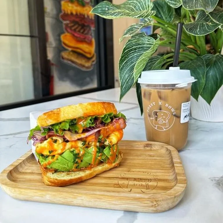 Gourmet sandwich and latte art at a cozy café
