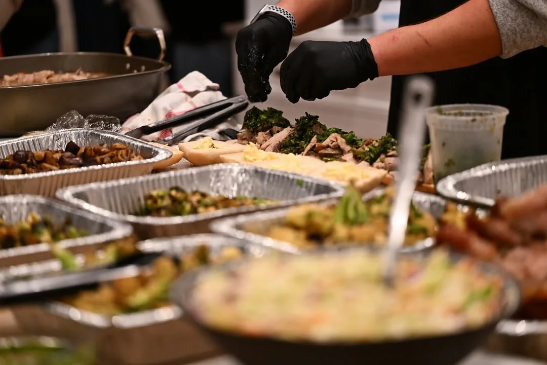 Chef preparing a vibrant platter of Asian-inspired dishes