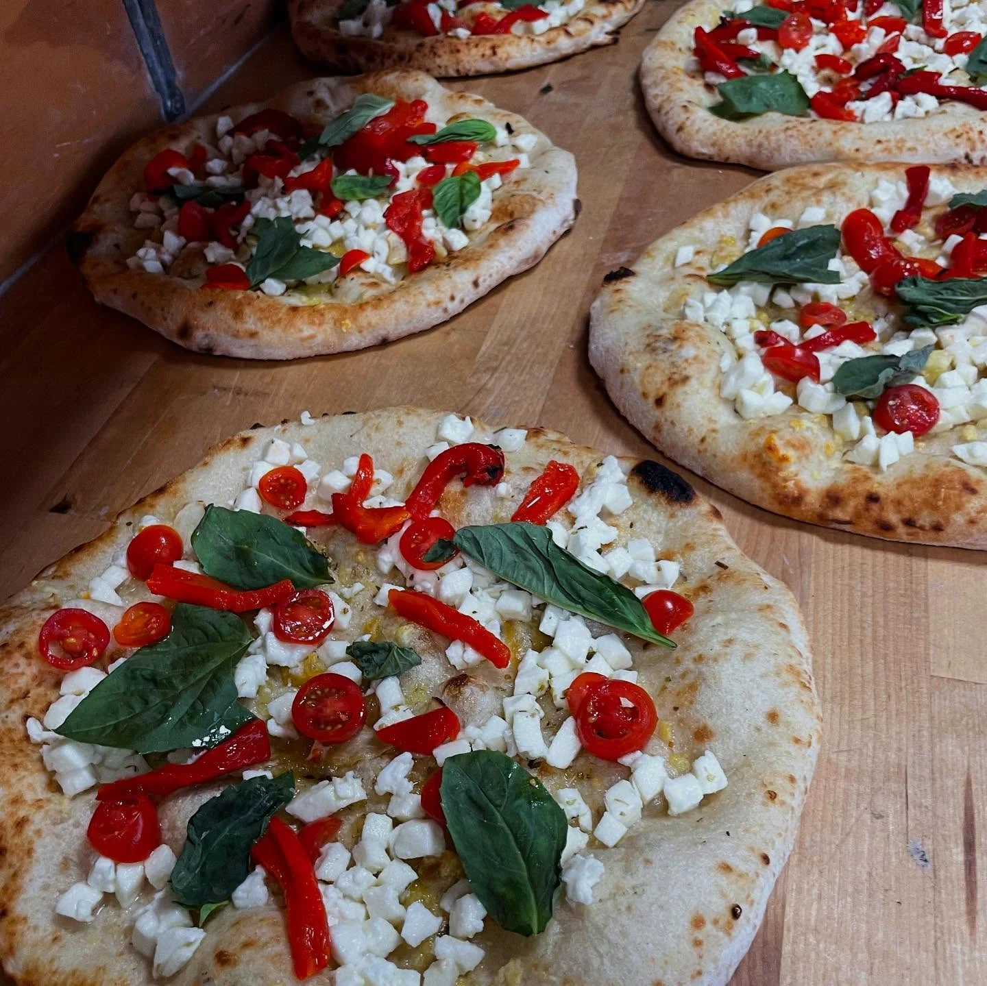 Freshly baked Italian pizza with basil and cherry tomatoes