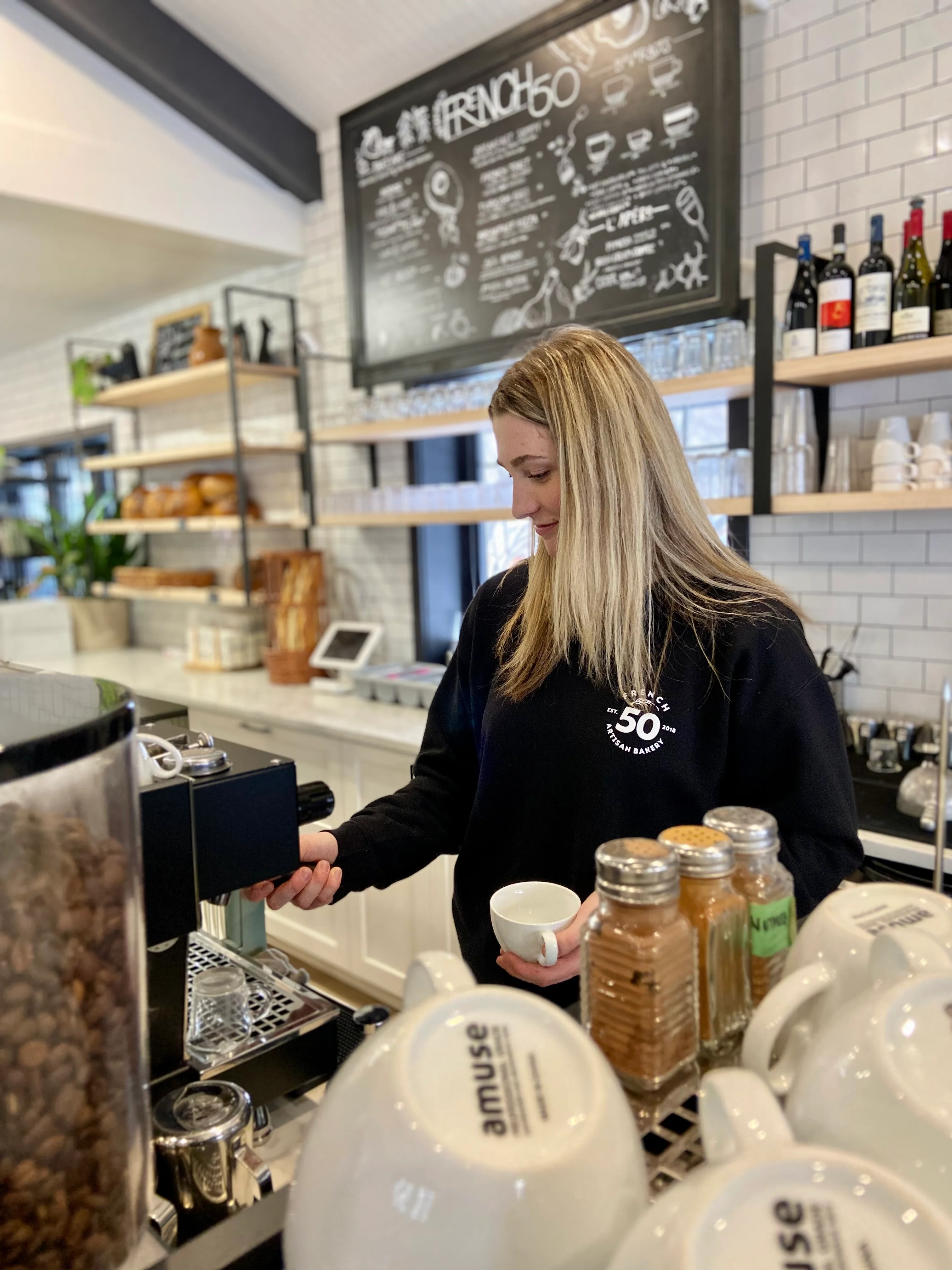 Barista preparing coffee in a modern café setting