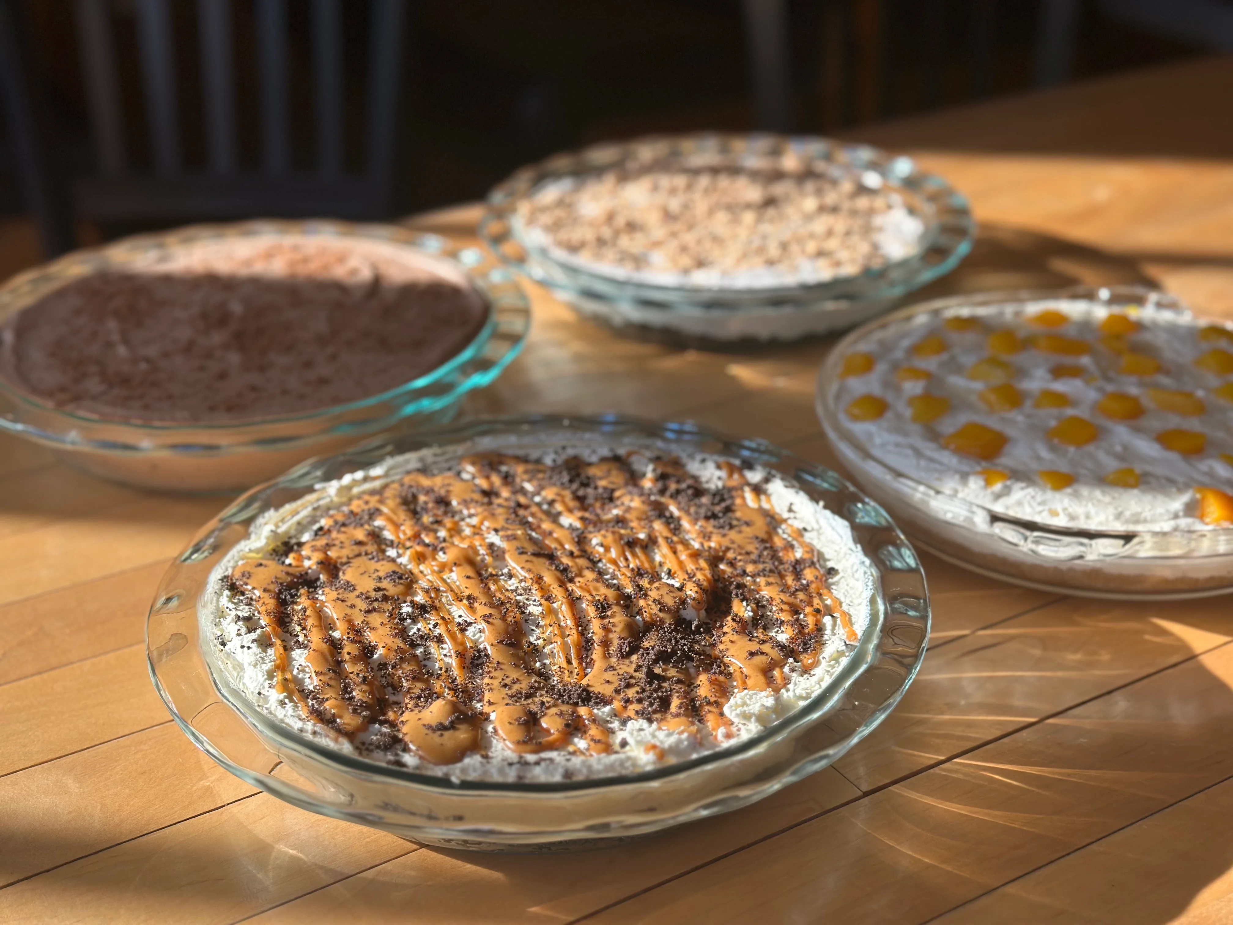 Assorted no-bake cream pies with various toppings