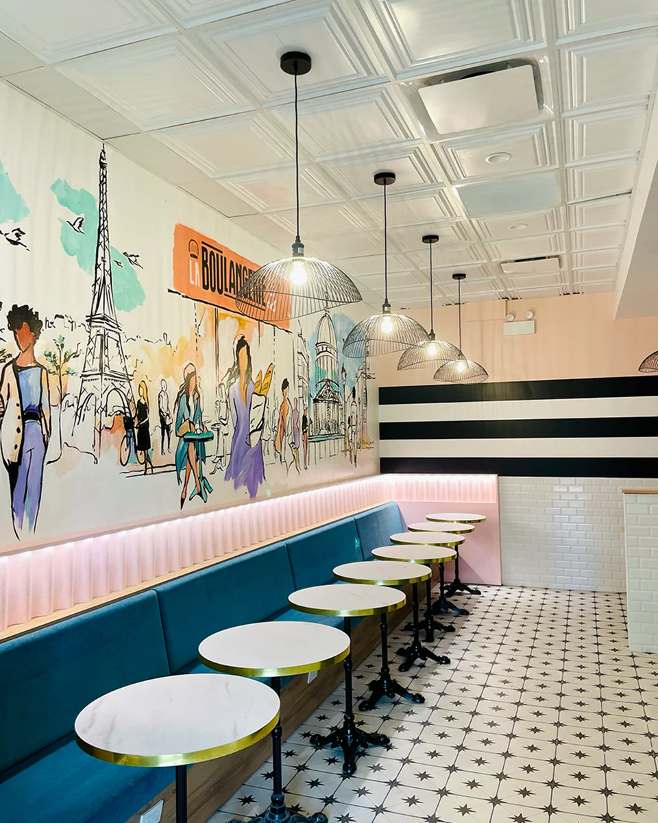 Mural wall and seating area inside La Boulangerie & Co Hyde Park café.