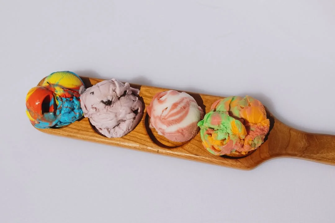 Colorful ice cream scoops on a wooden paddle