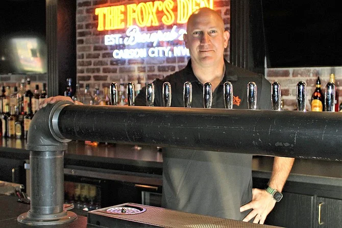Bartender at a modern bar with craft beer taps