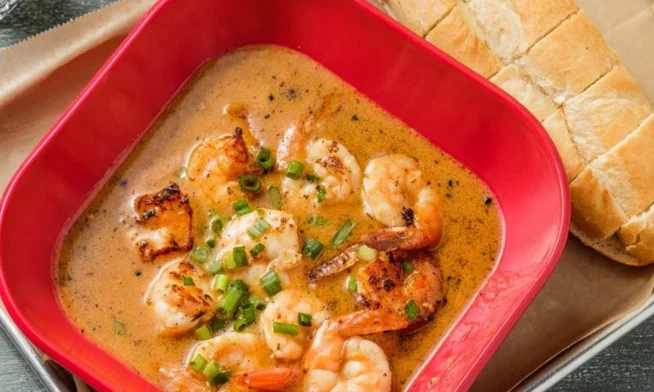 N’awlins BBQ shrimp from VooDoo BBQ in Pensacola, featuring sautéed shrimp in a spicy buttery BBQ sauce served with Leidenheimer French bread.