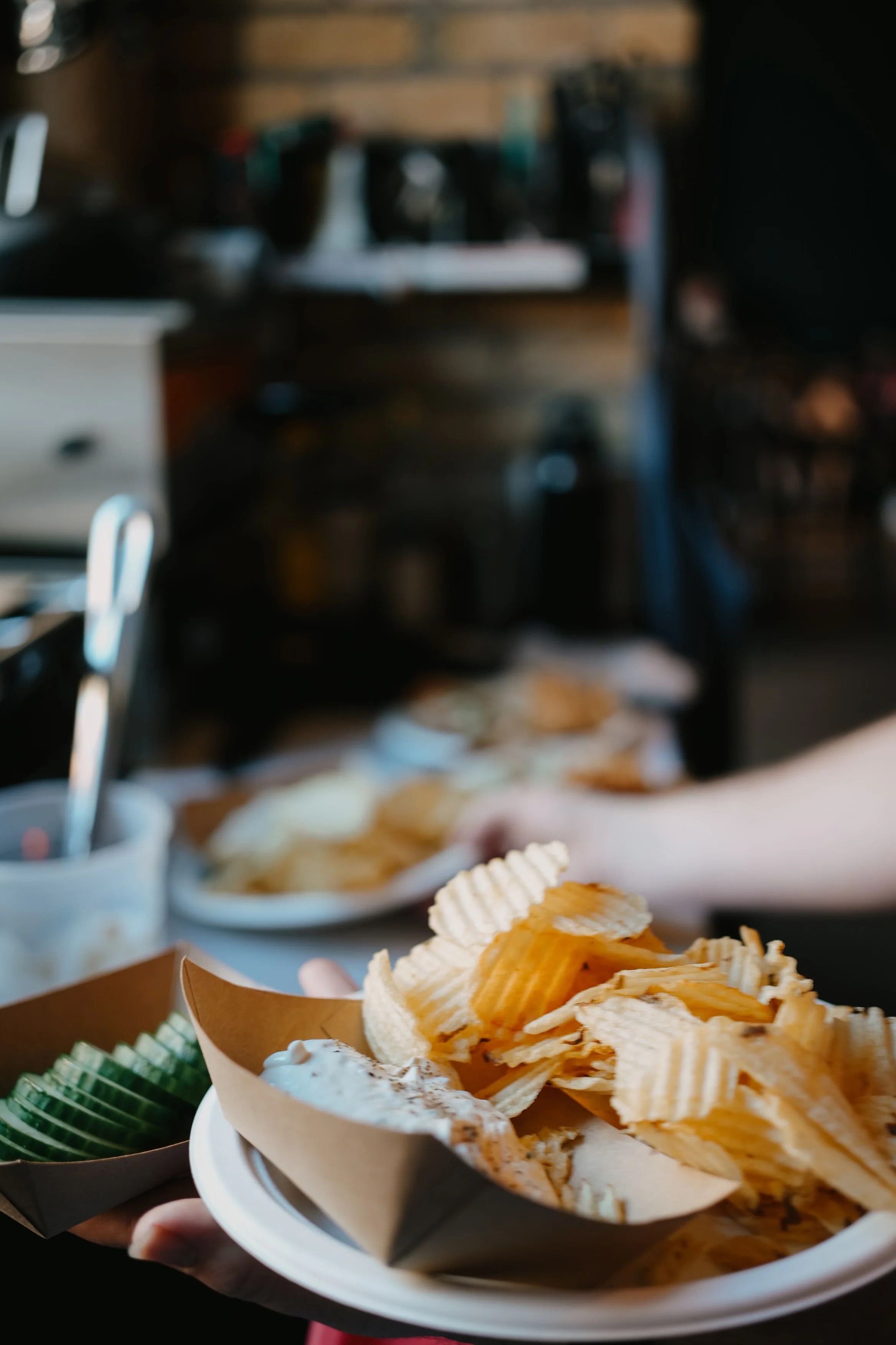 Crispy potato chips served with dip in a casual dining setting