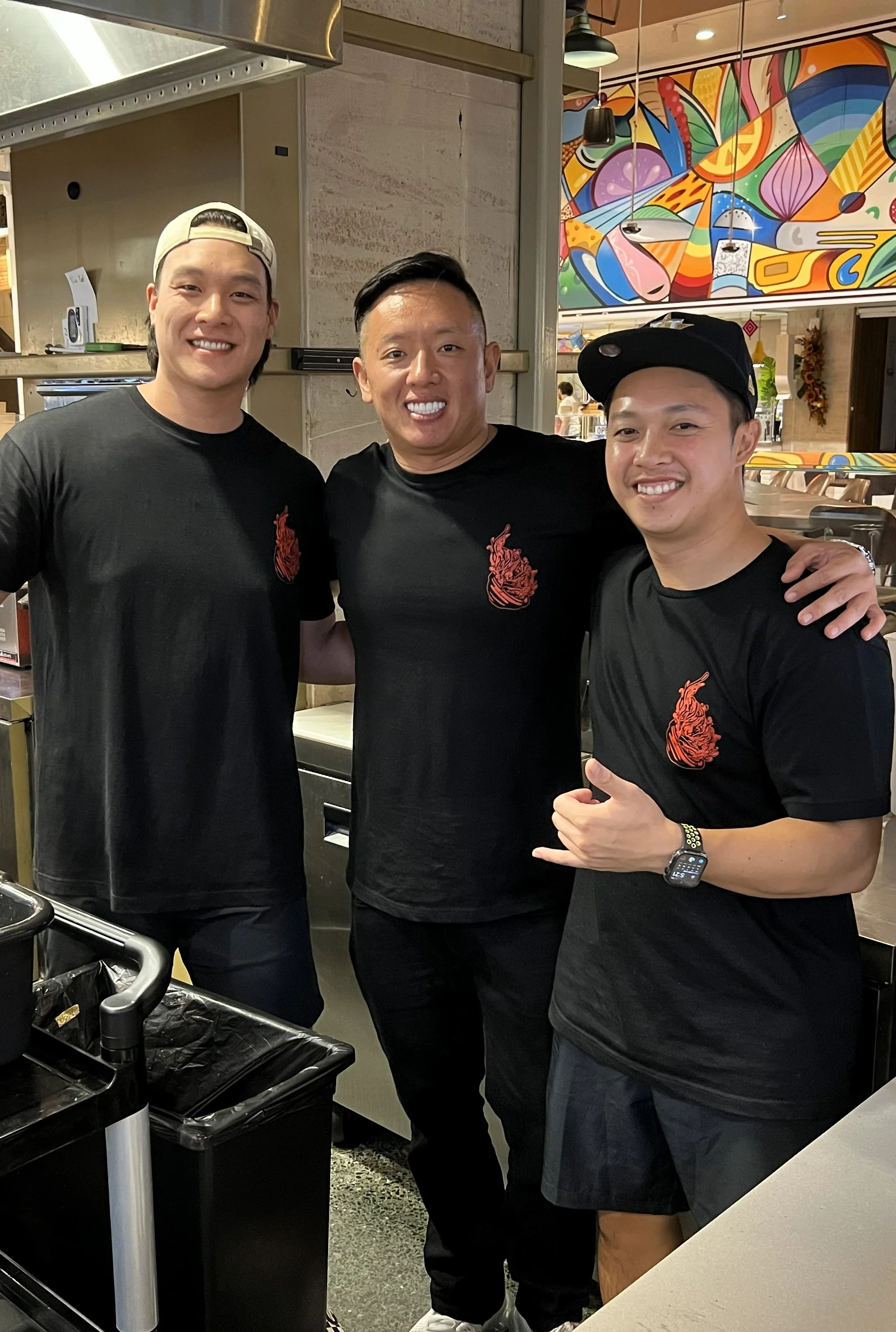 Chefs posing in a vibrant restaurant kitchen