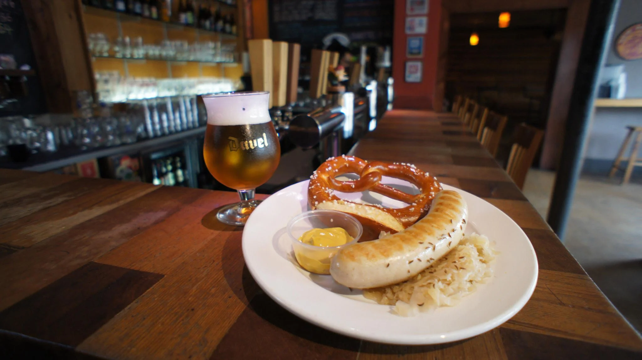 German sausages with pretzel and mustard in a cozy bar setting