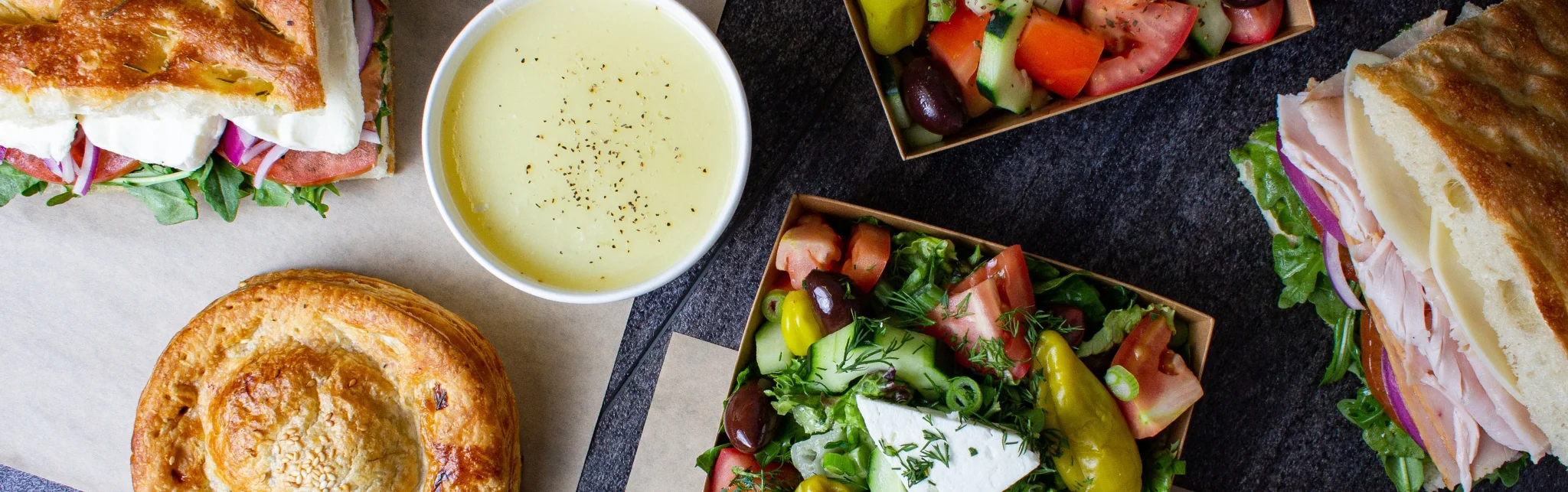 Mediterranean sandwich platter with soup and fresh salads