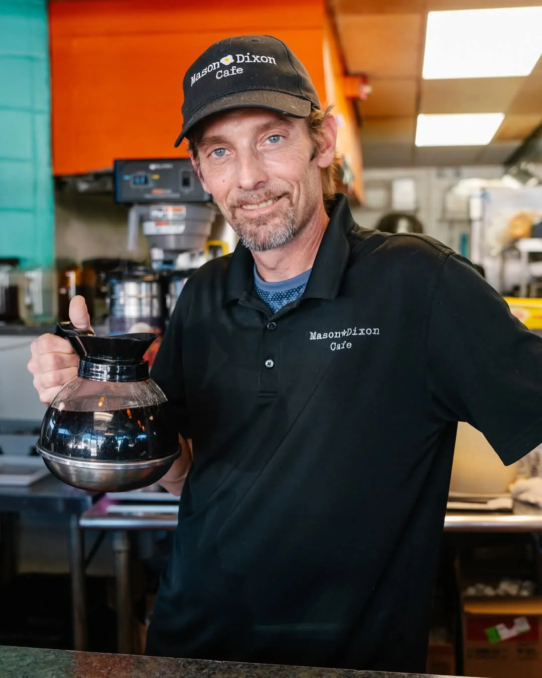 Barista serving coffee at Mason Dixon Cafe