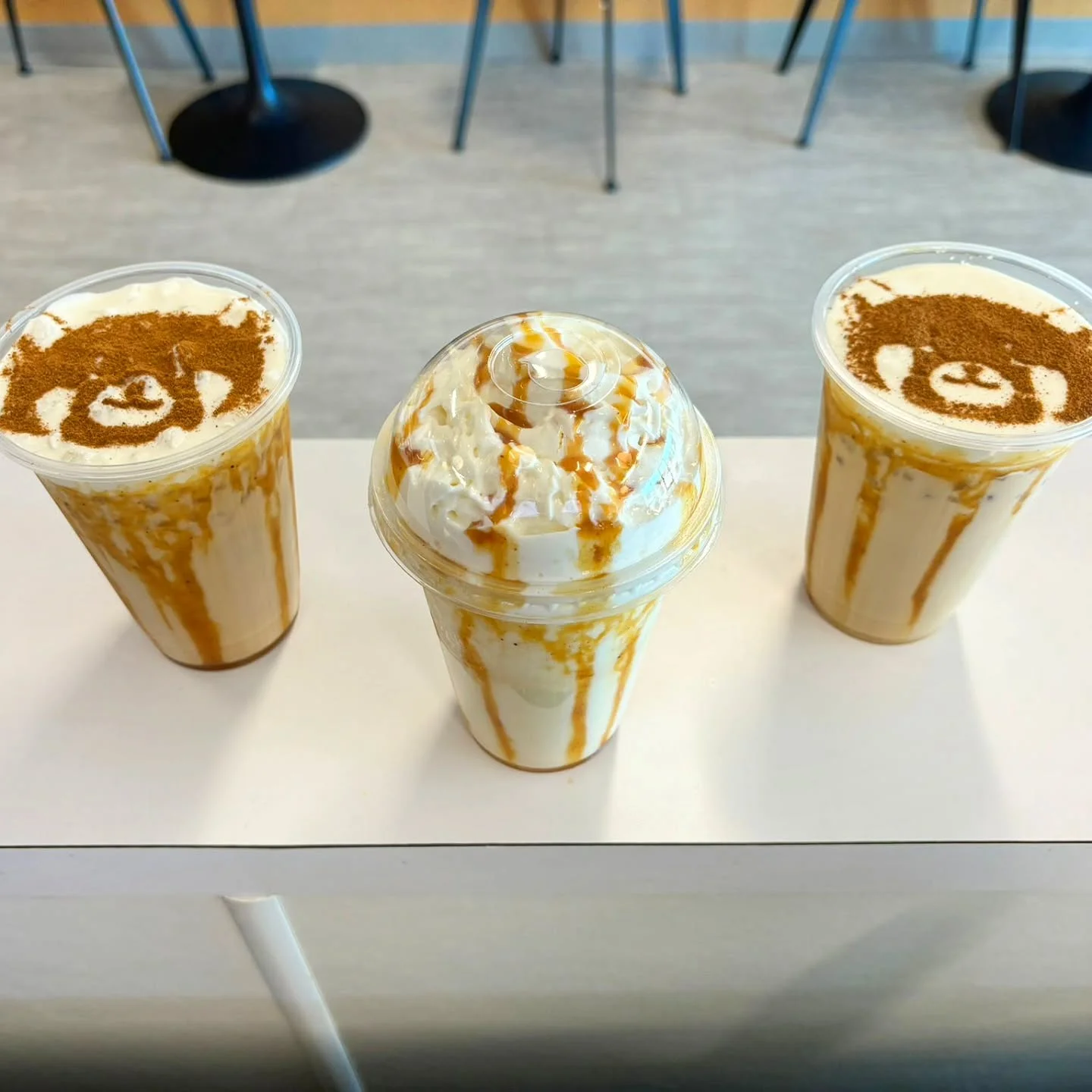 Artistic coffee drinks with whipped cream and caramel drizzle
