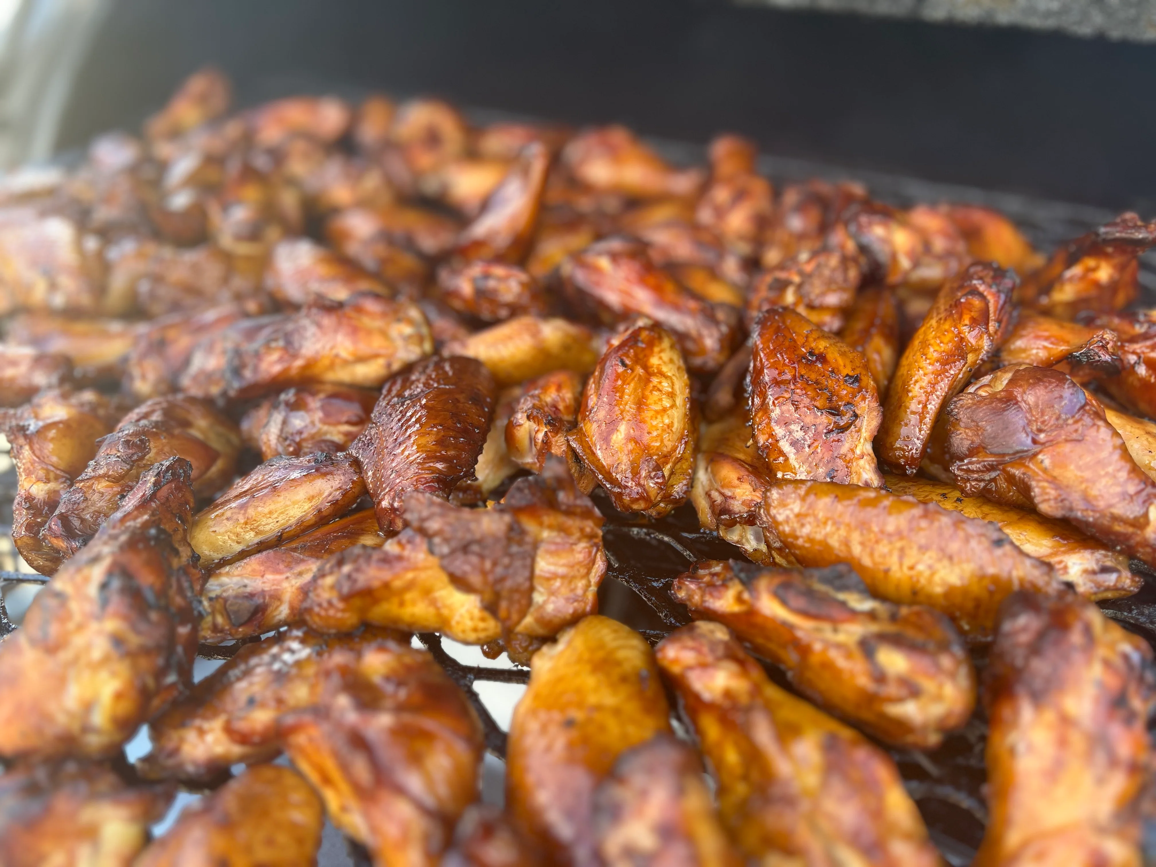 Smoky barbecue chicken wings on a grill