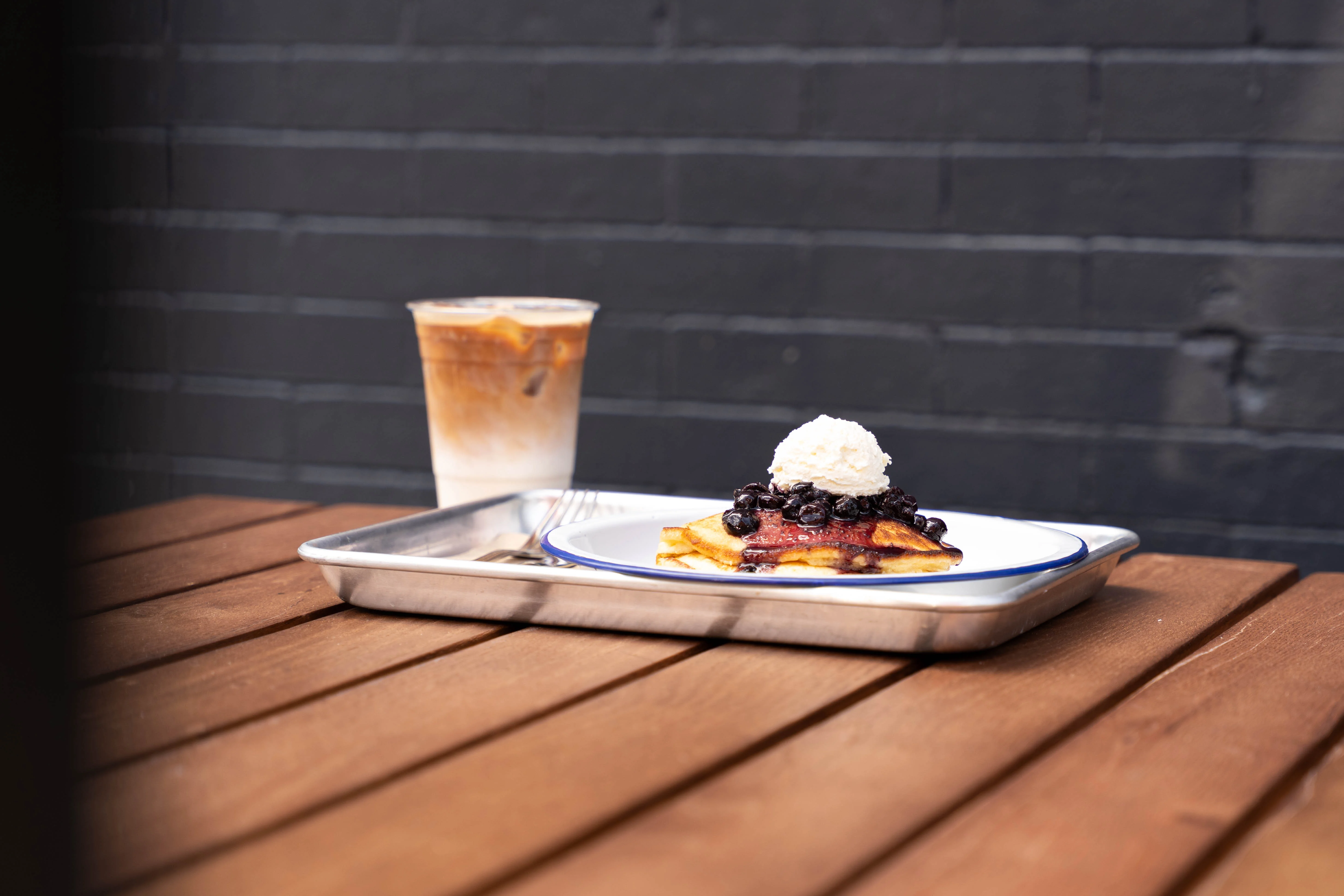 Fluffy pancakes topped with blueberries and whipped cream