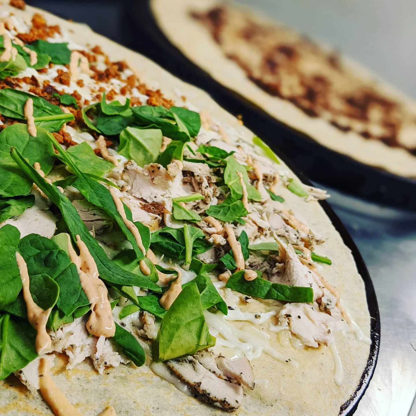 Grilled chicken wrap with fresh spinach and sauce