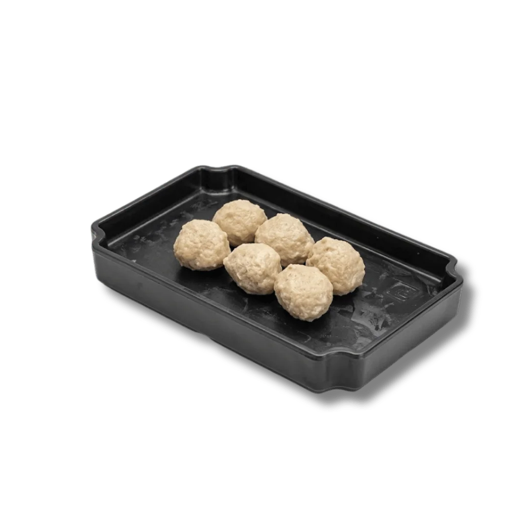 Six meatballs in a black plastic tray.