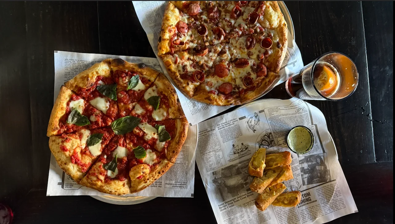 Two pizzas including Margherita and pepperoni with craft beer