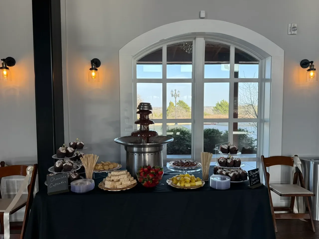 Dessert table with chocolate fountain and assorted treats