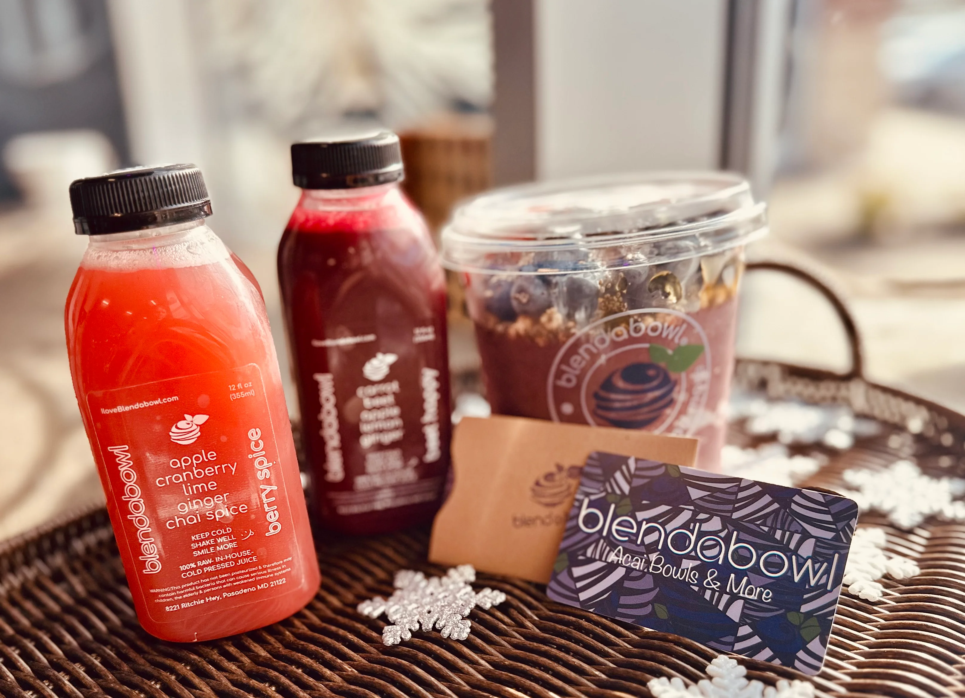 Gift card displayed with a juice and bowl of food on a table.