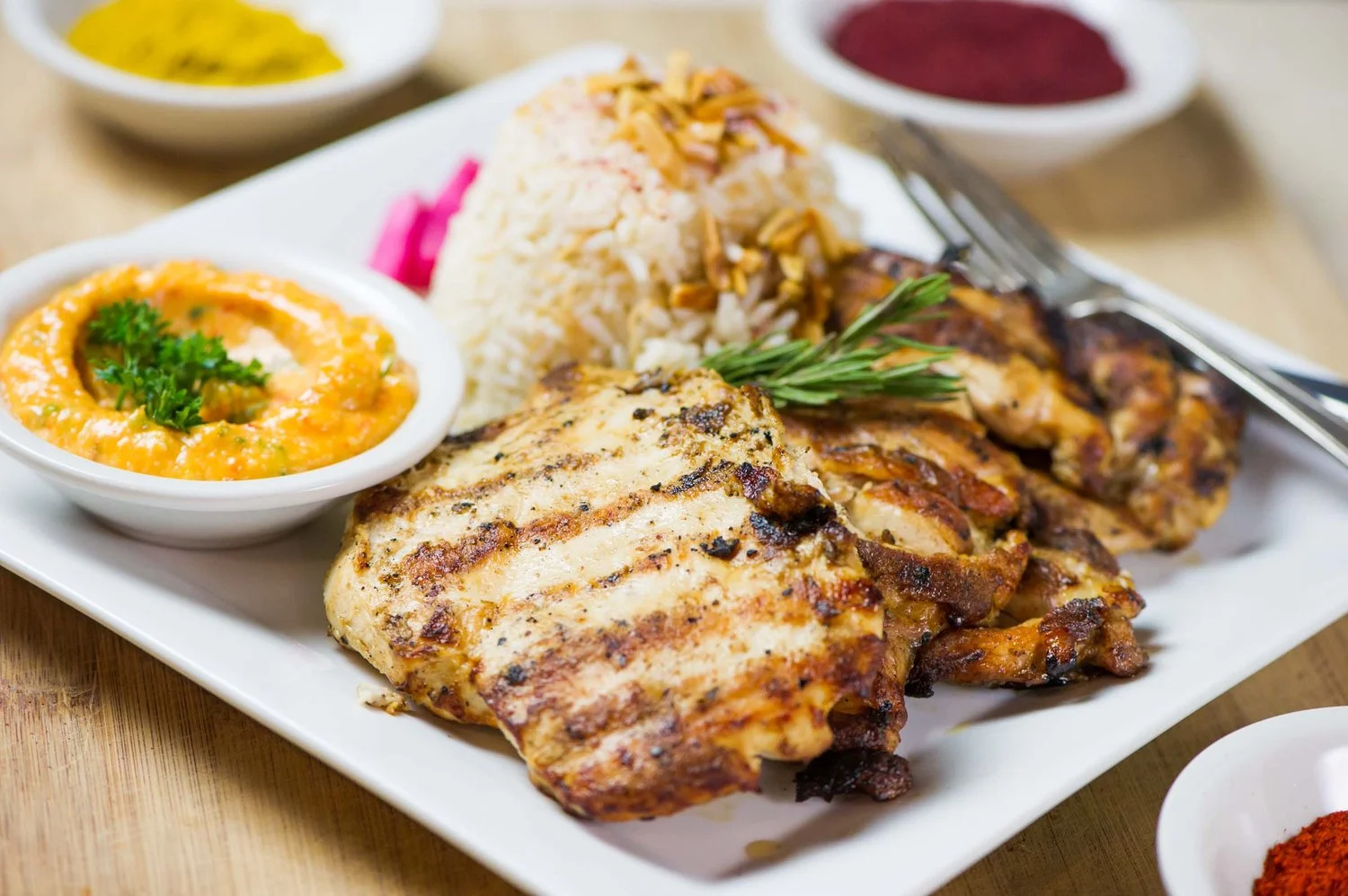 Grilled chicken kabob served with rice and fresh salad at Malek Al Kabob