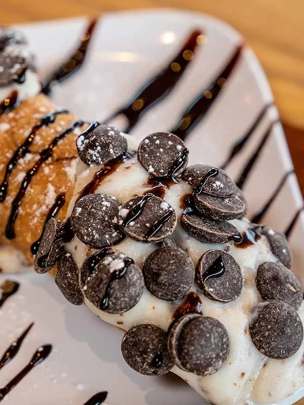 Decadent Italian cannoli topped with chocolate chips