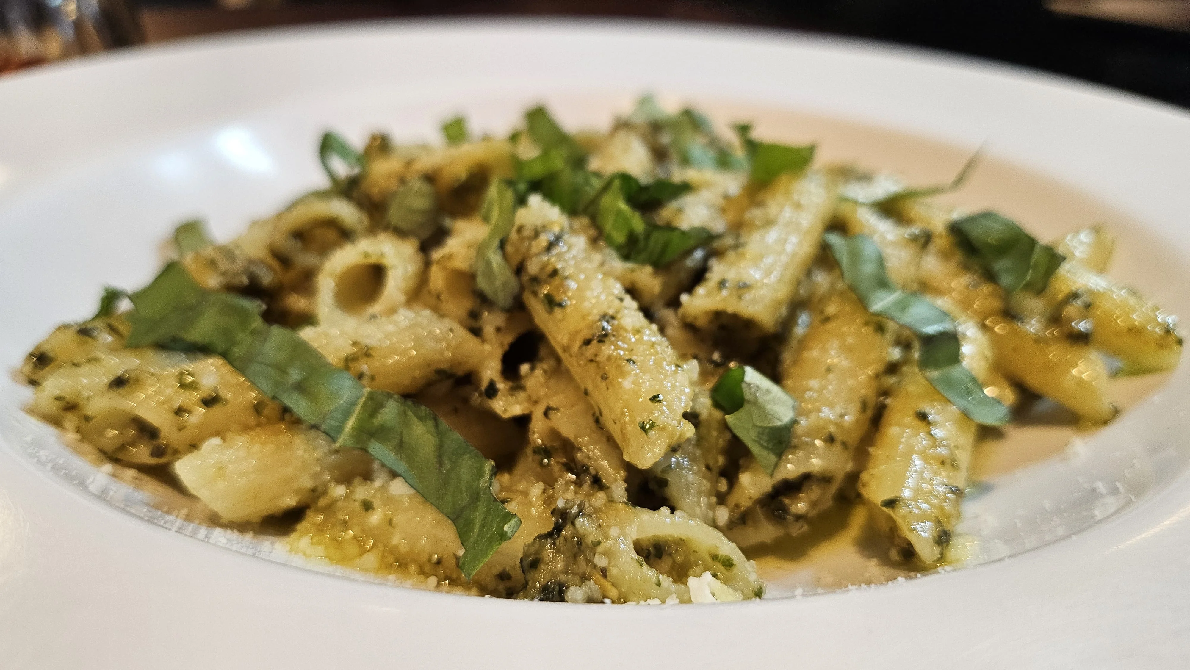 Pasta al pesto with fresh basil garnish