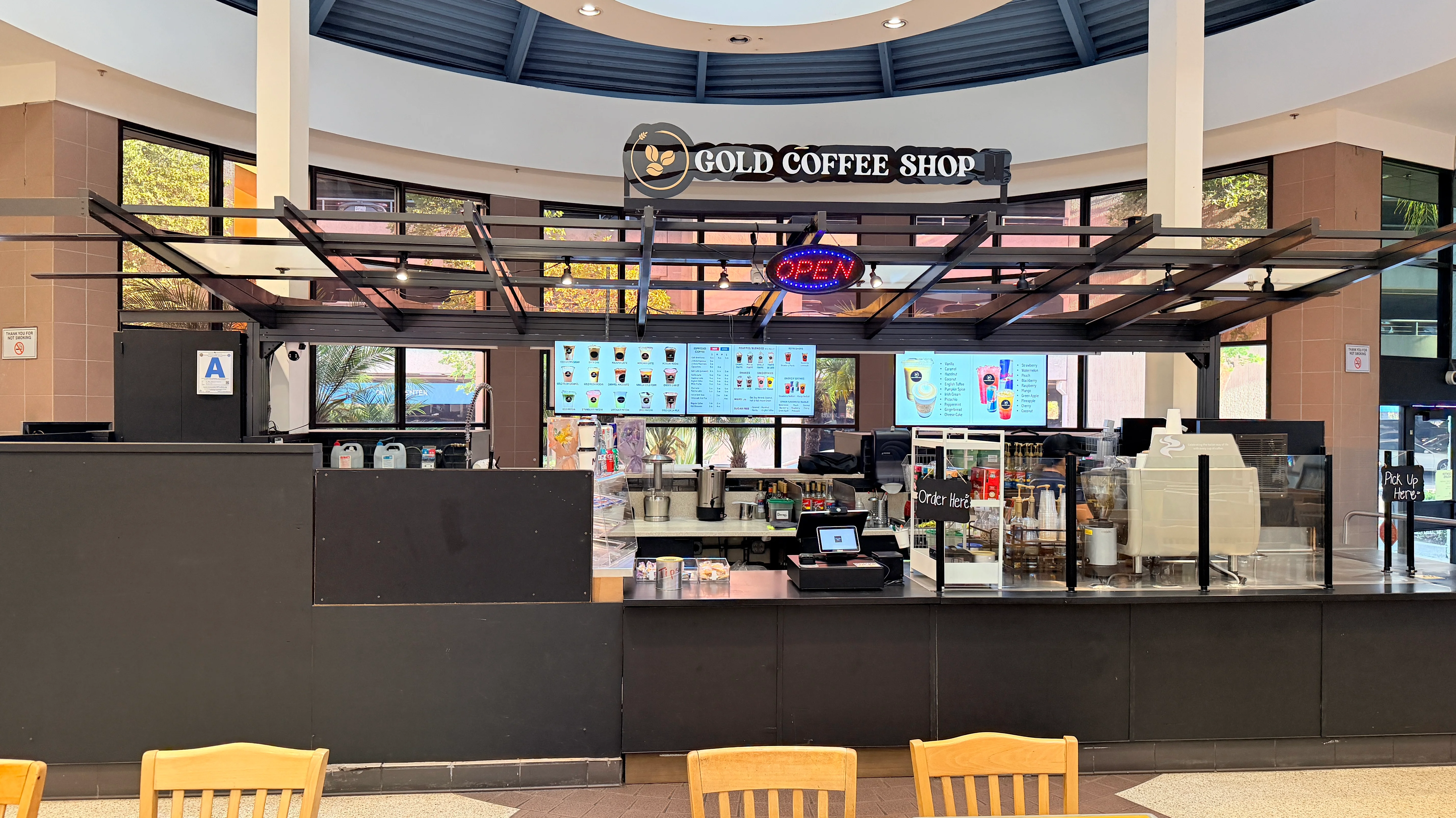 Interior view of Gold Coffee Shop with menu and open sign.