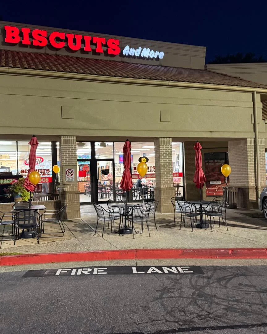 Exterior of Biscuits And More restaurant at night with outdoor seating