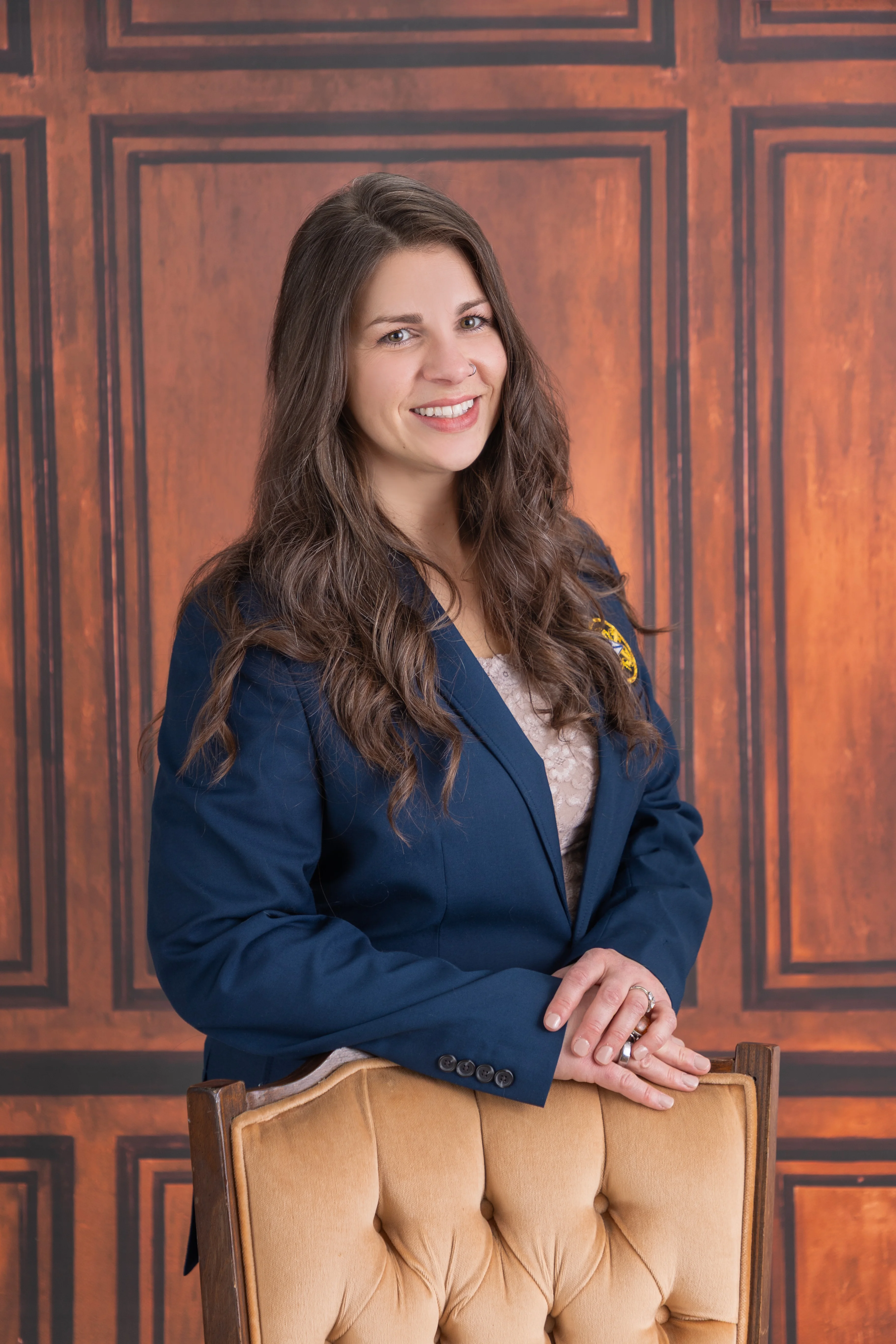 Professional portrait of a woman in a navy blazer