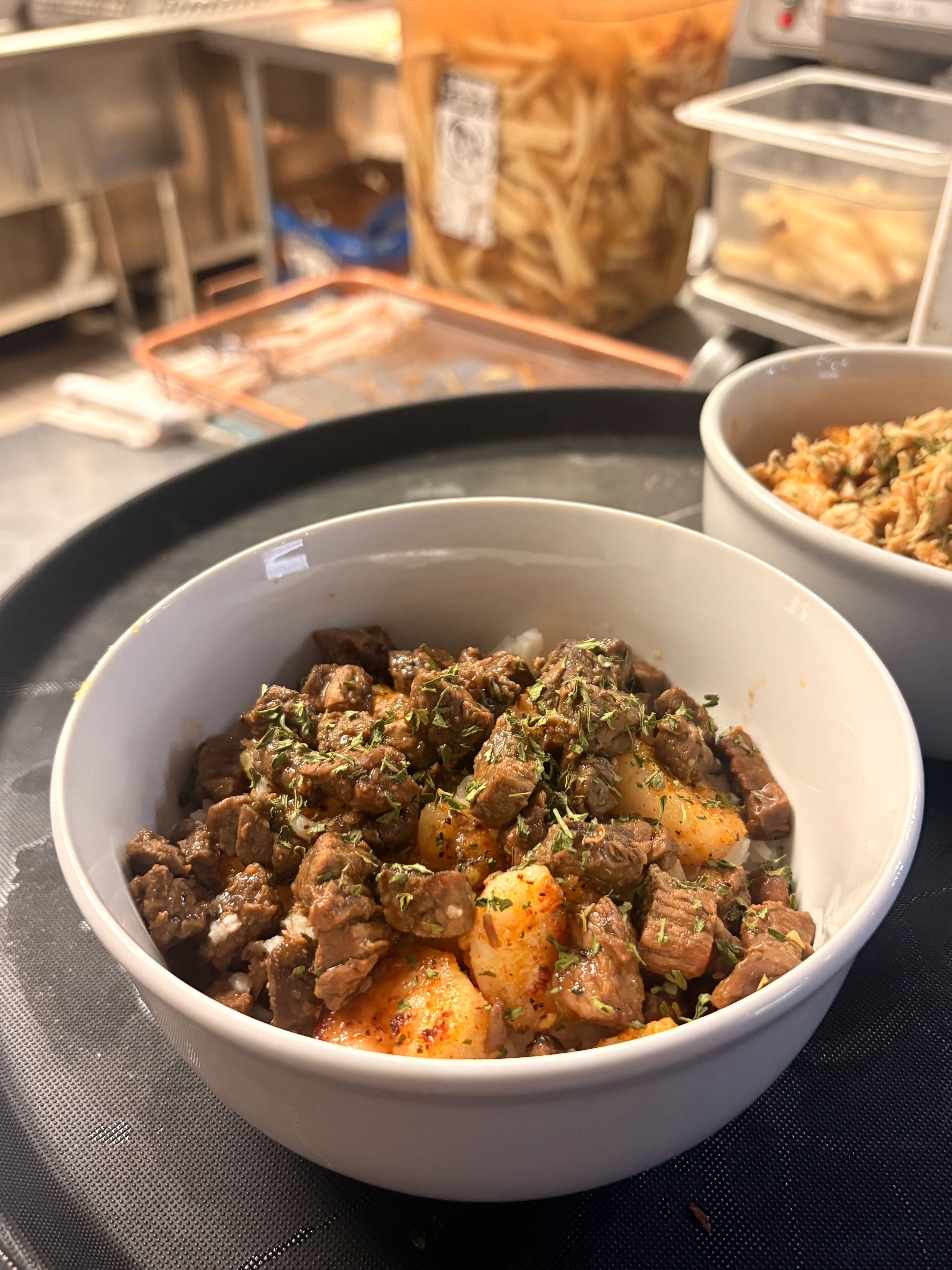 Savory beef stew served over rice in a cozy restaurant setting