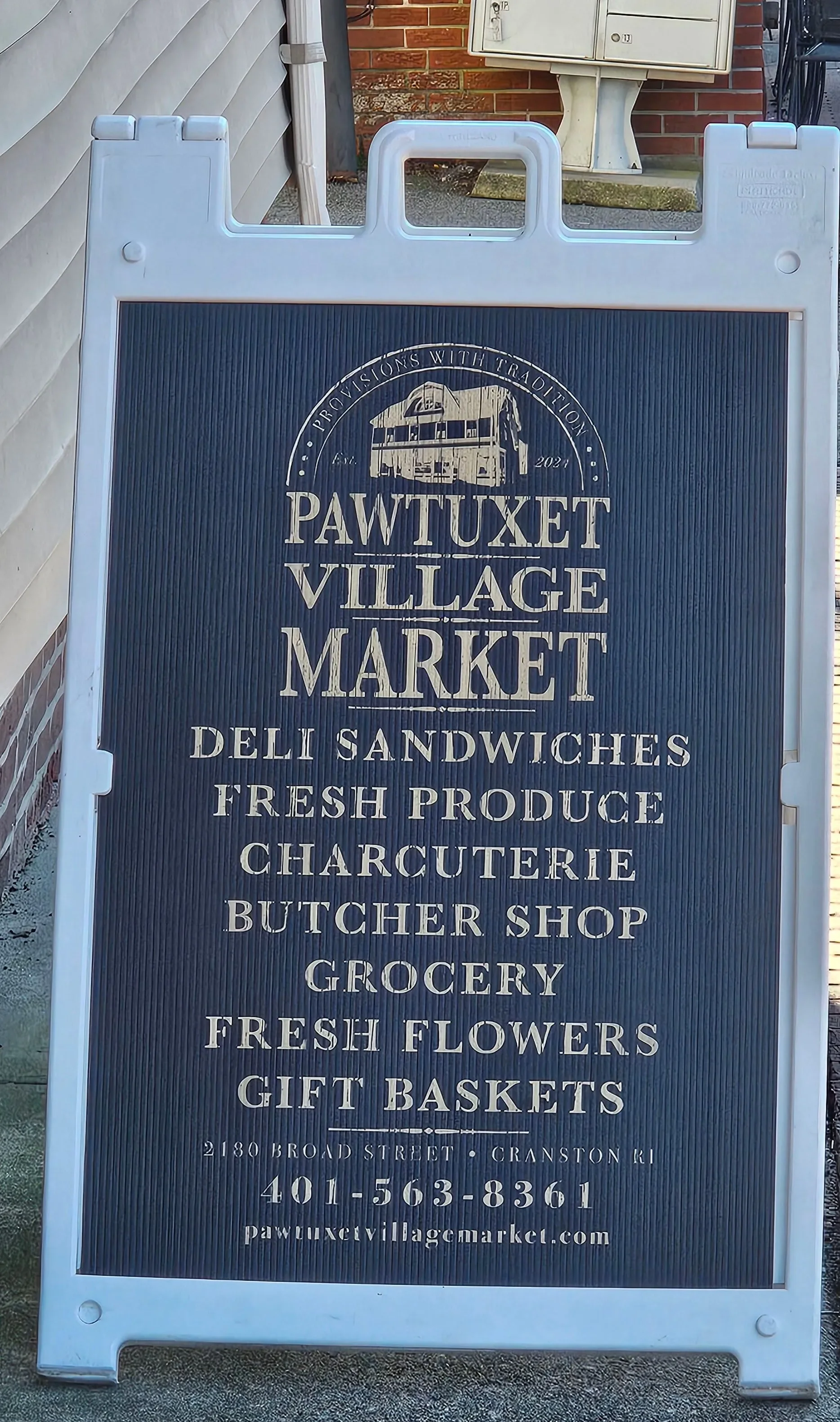 Sign for Pawtuxet Village Market with deli and grocery offerings