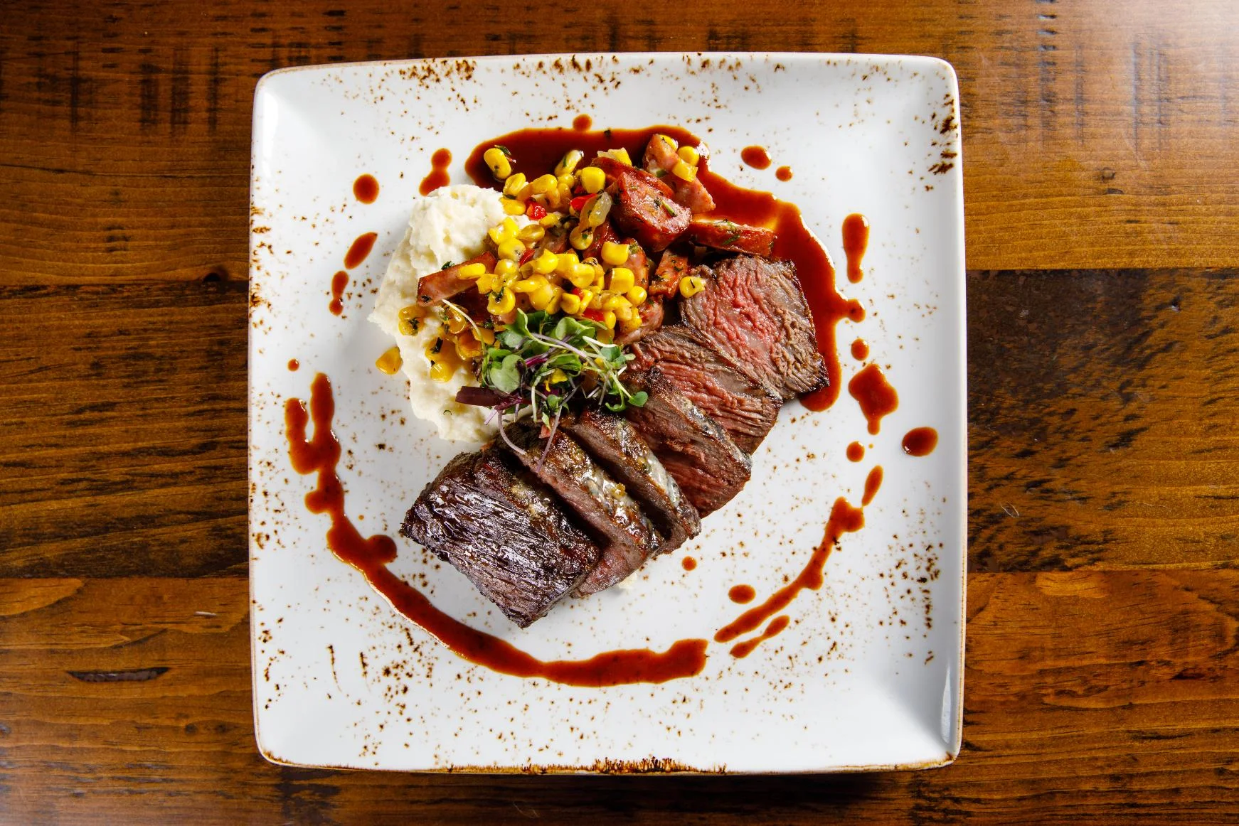 Grilled steak with mashed potatoes and corn salsa