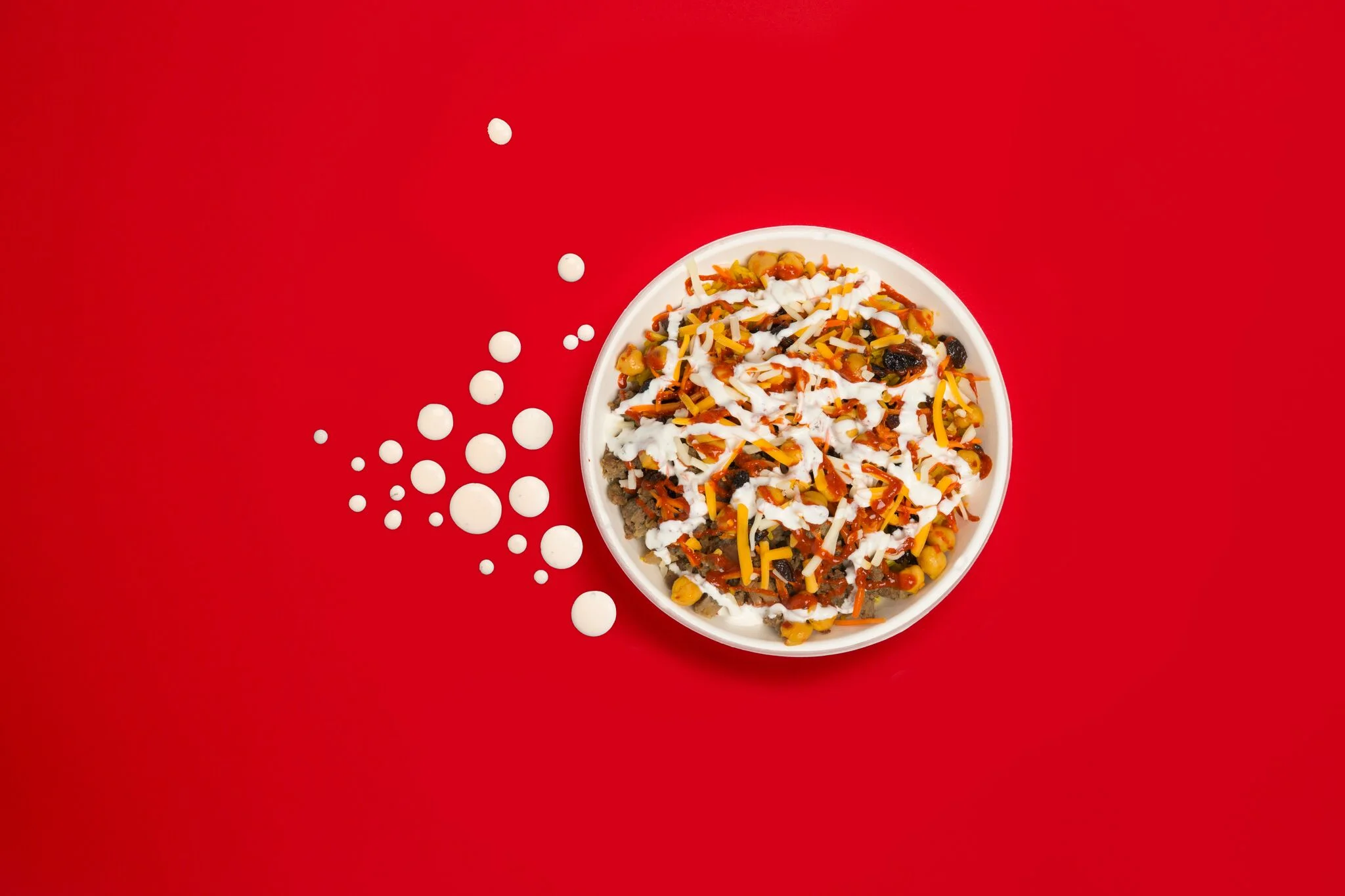 Bowl of Mexican chili with toppings