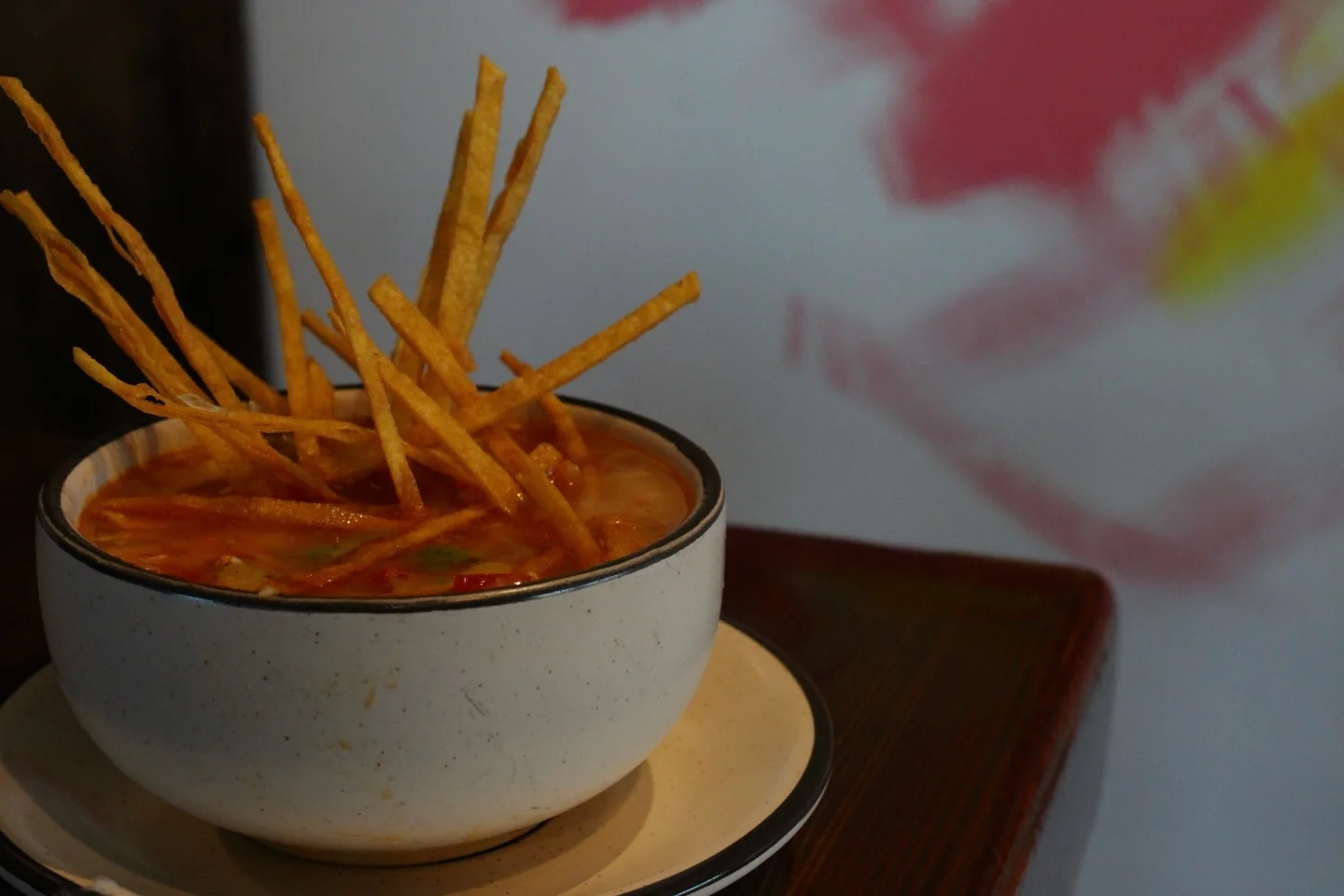 Bowl of Mexican tortilla soup topped with crispy tortilla strips