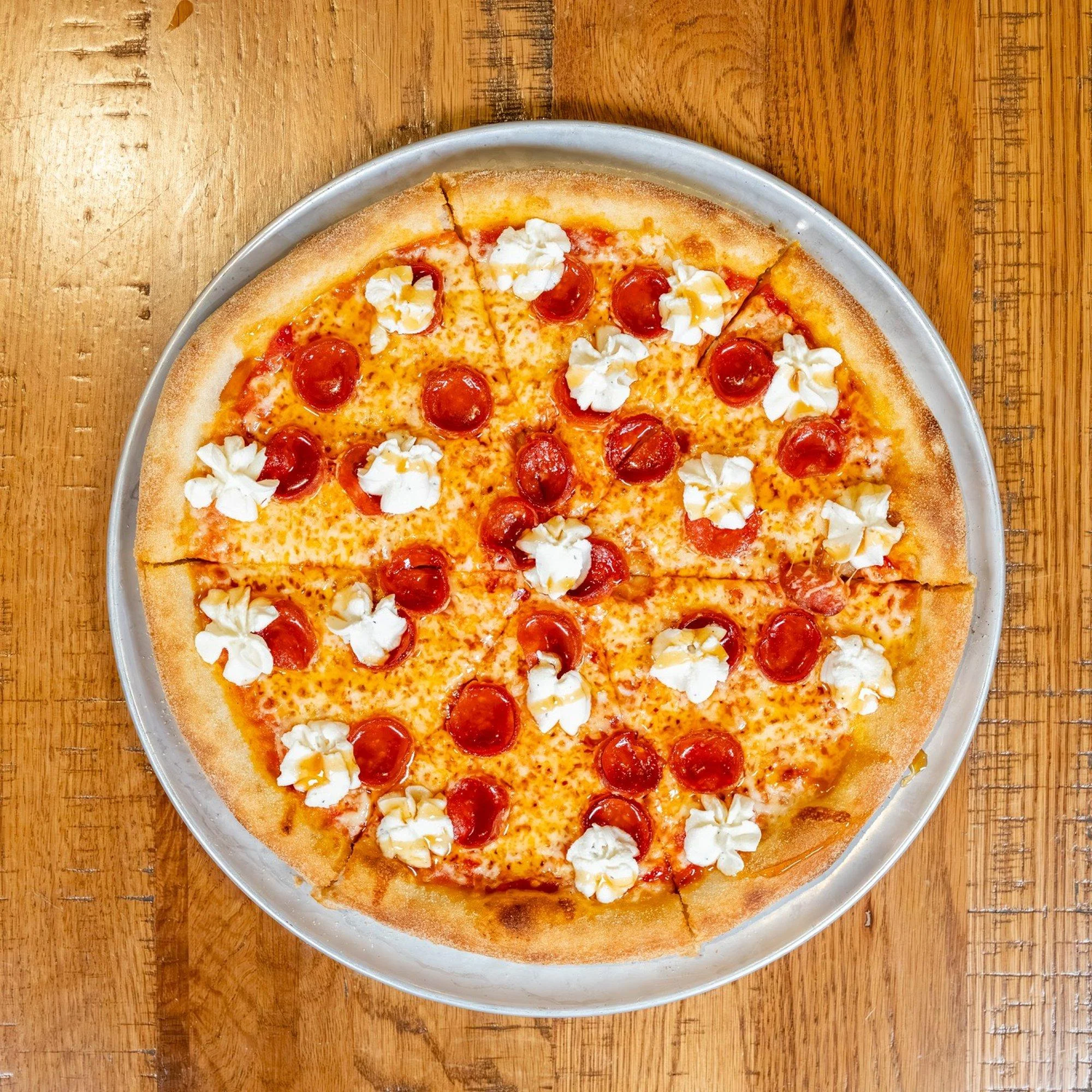 "Sting Like a Bee" pizza with pepperoni, fresh ricotta, mozzarella, and Mike's Hot Honey — Amici Brick Oven Pizza signature pie, West Palm Beach