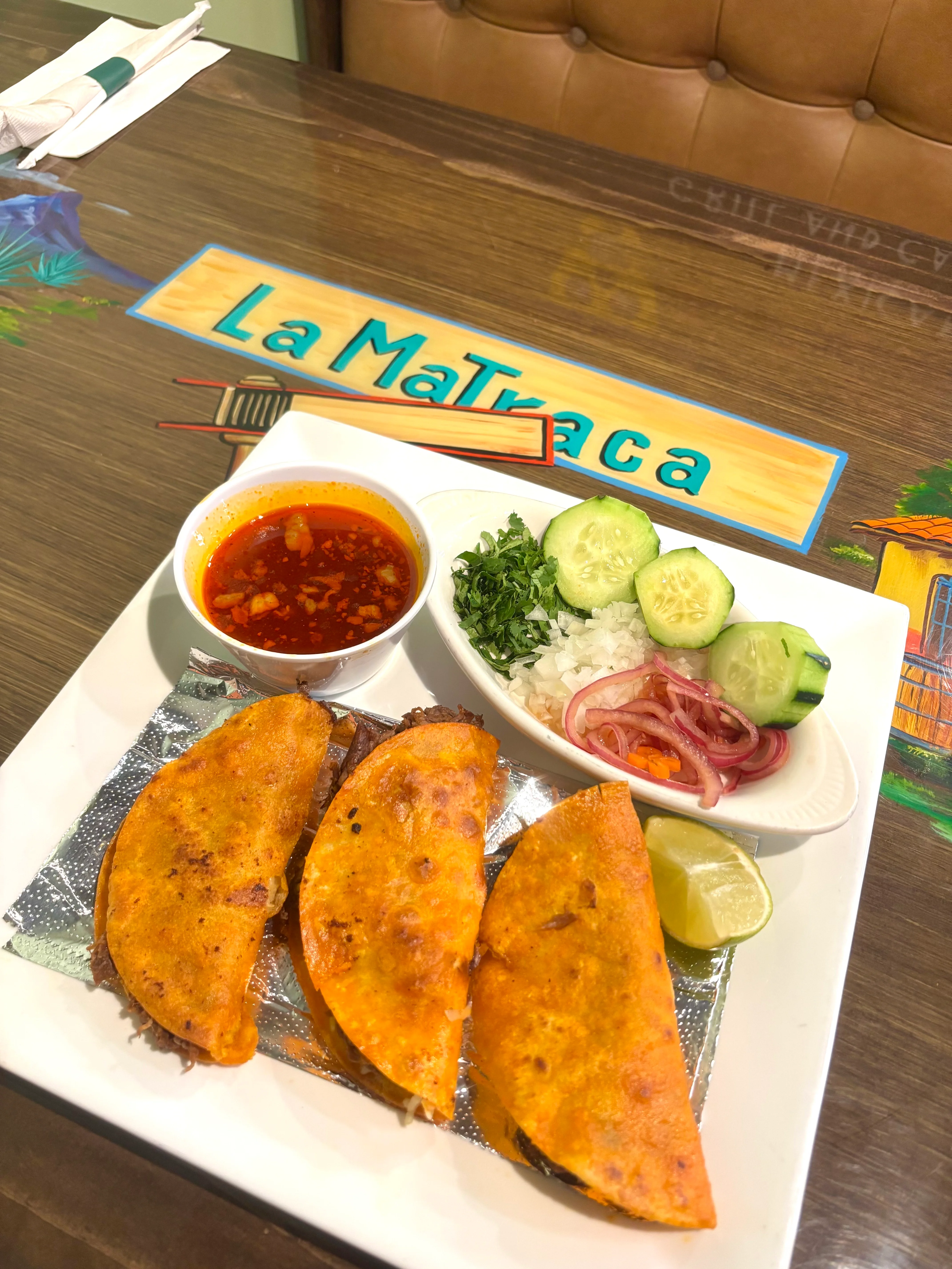 Three crispy tacos with salsa and fresh toppings