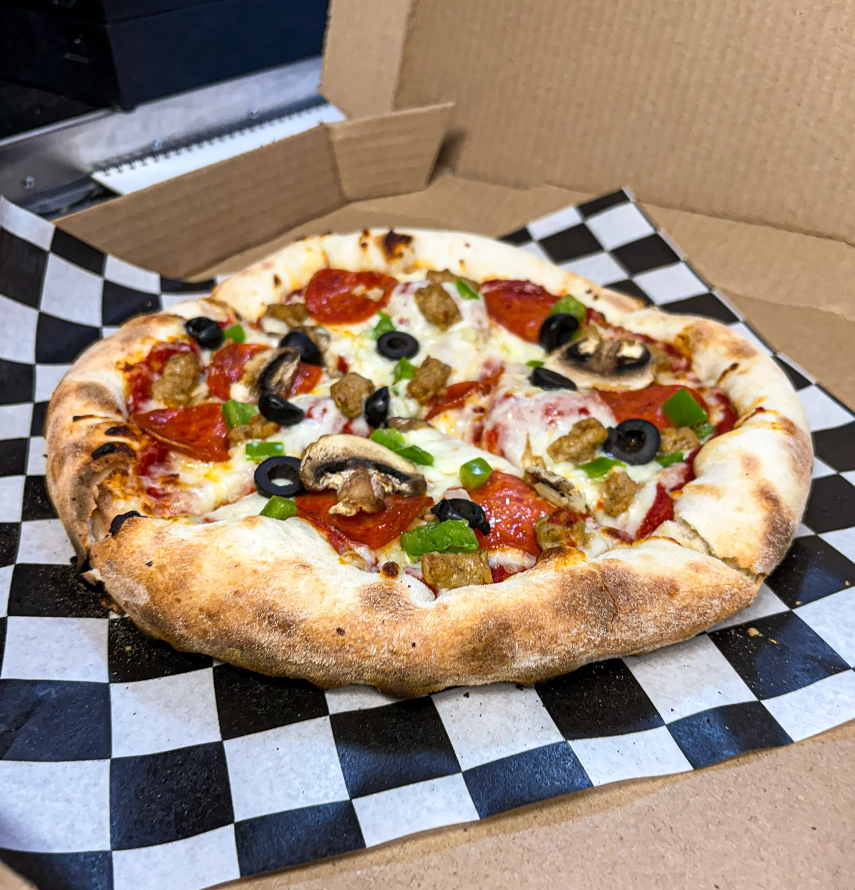Pepperoni pizza with cheese and herbs