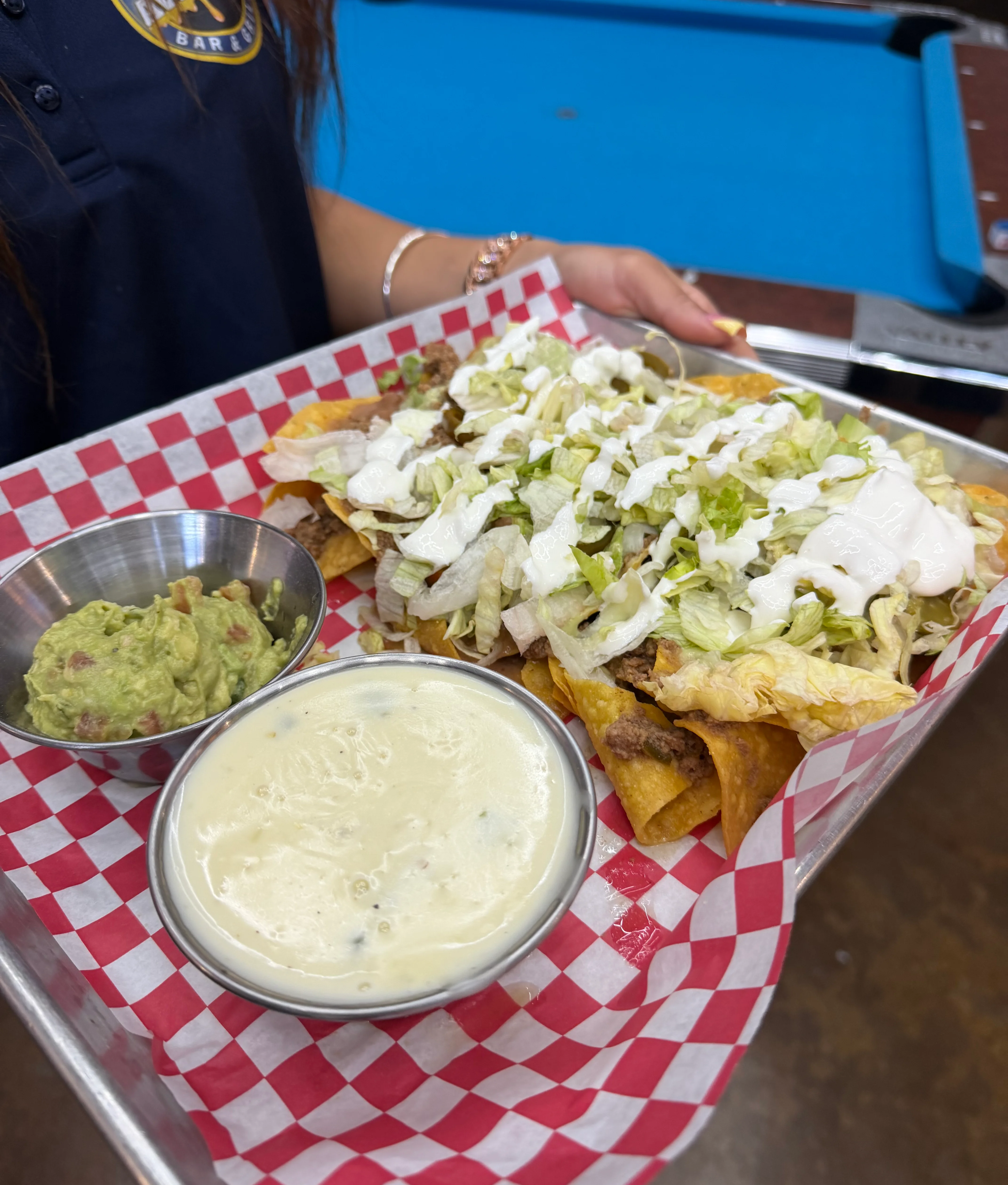 Loaded nachos with beef, lettuce, and guacamole