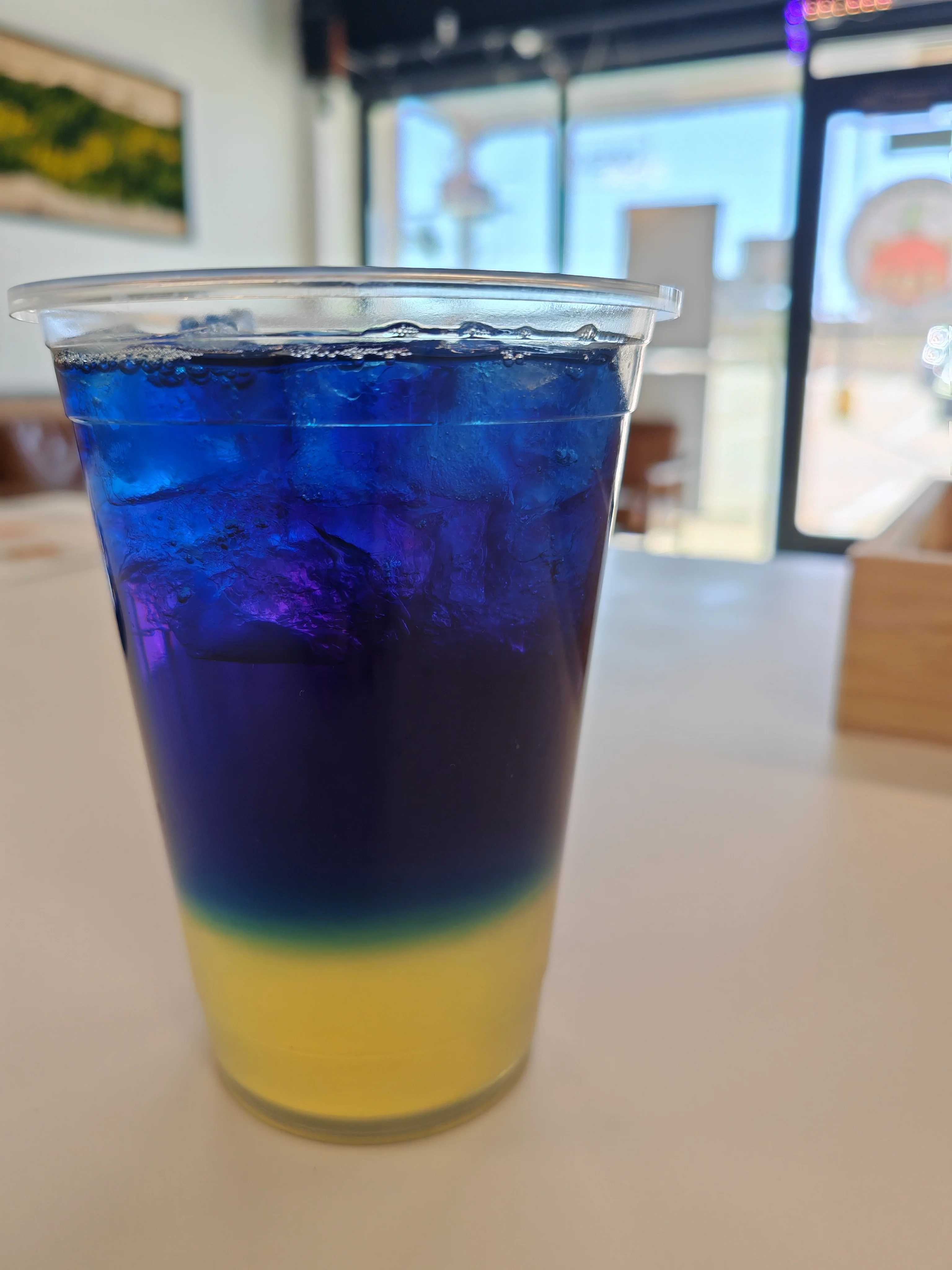 Colorful layered drink in a clear cup