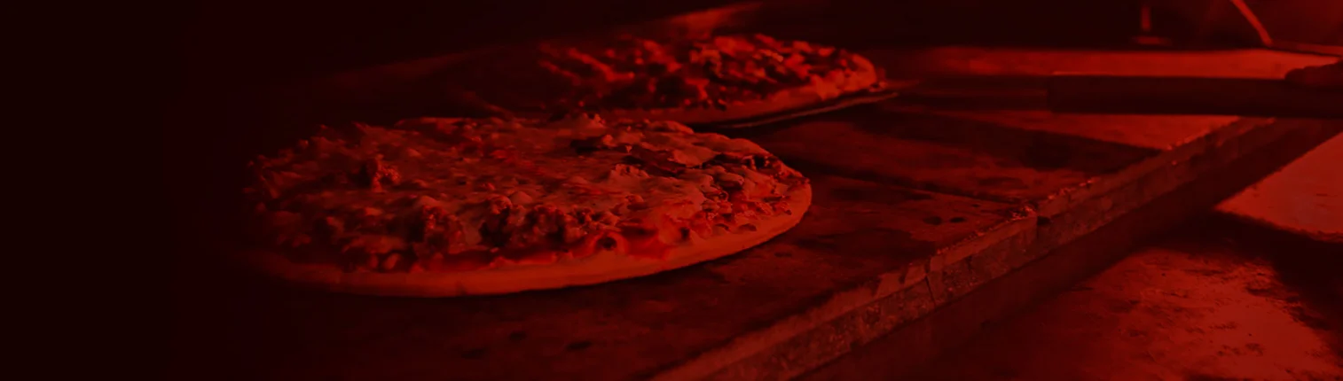 Freshly baked Margherita pizza in a wood-fired oven