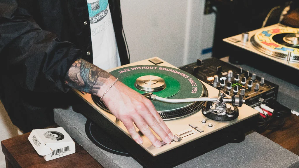 DJ mixing on turntables at a music event