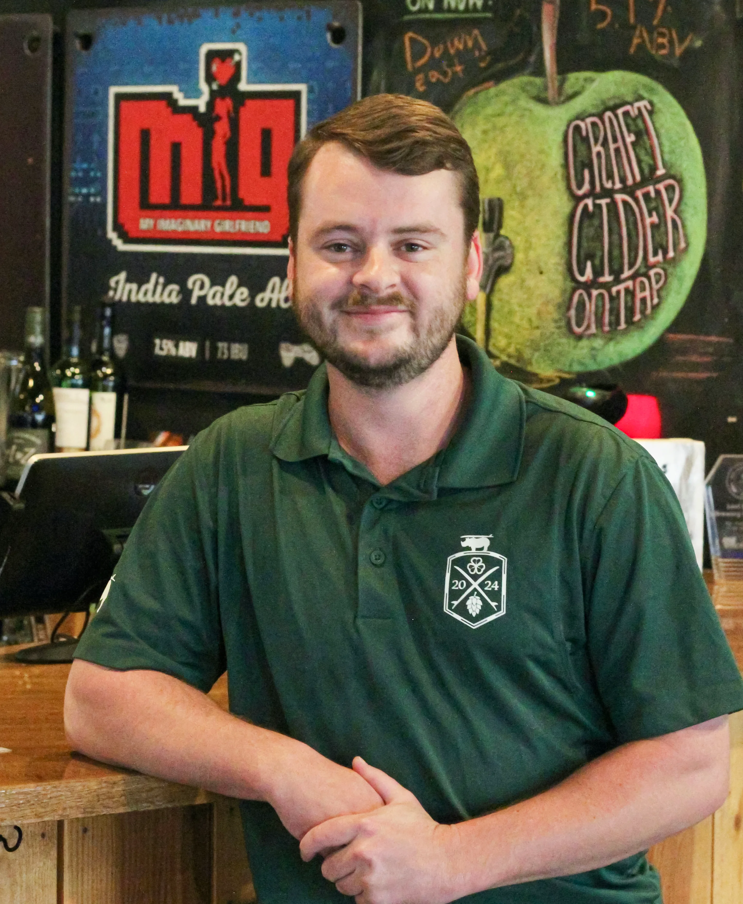 Bartender smiling at a craft beer bar counter