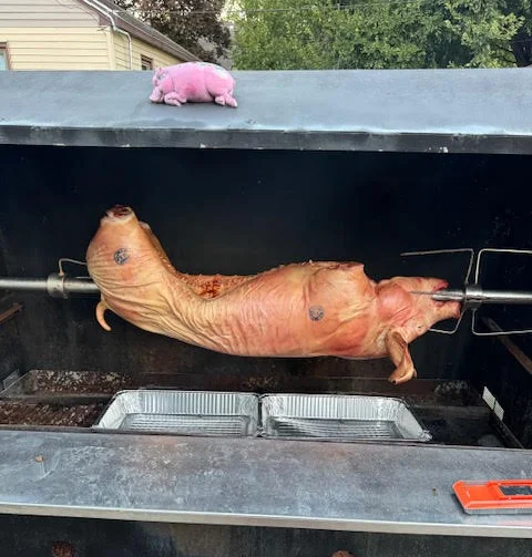 Whole roasted pig on a spit for a traditional feast