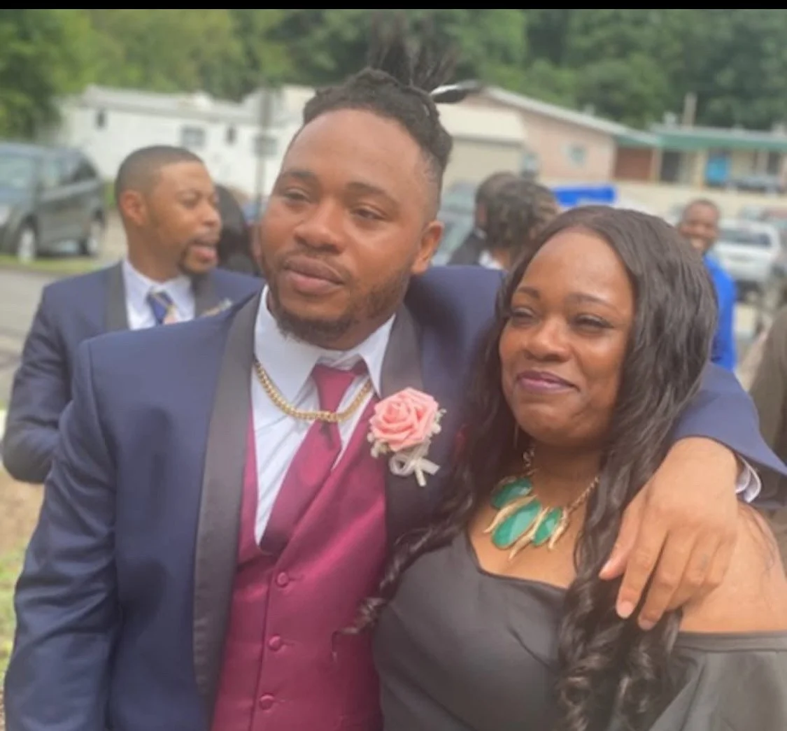 Two people posing together at a formal event, smiling and dressed elegantly