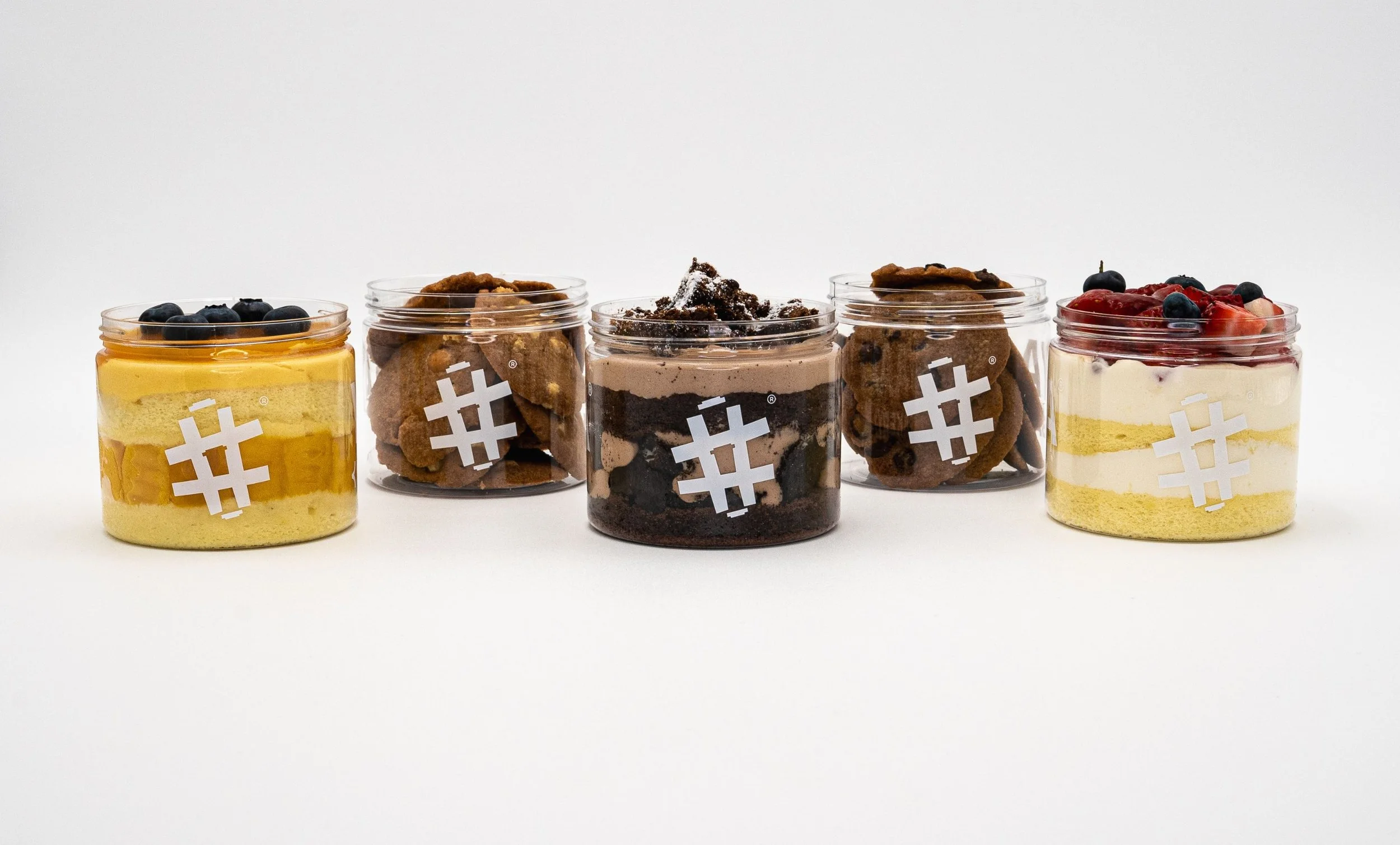Assorted dessert jars featuring layered cakes and toppings