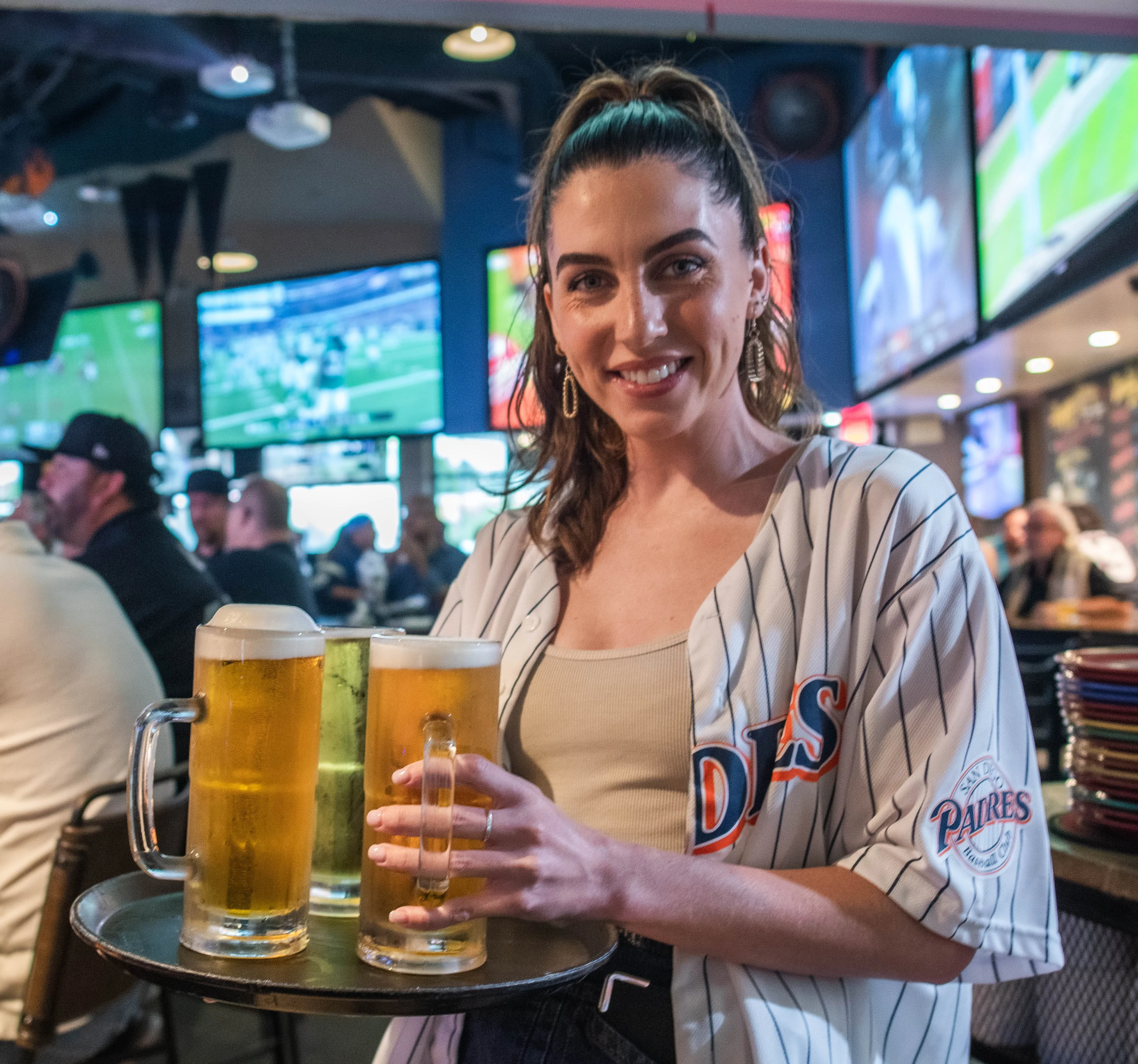 A waitress pouring drinks