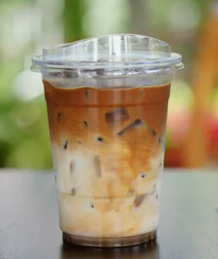 Iced coffee beverage with creamy milk and ice, perfect for warm days