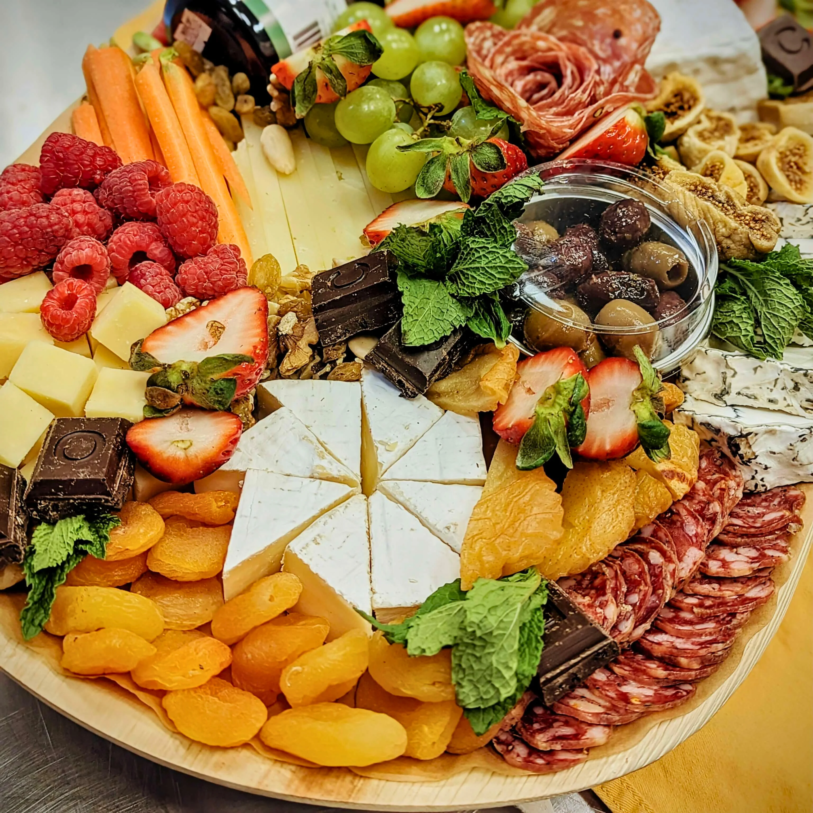 Artisan cheese and charcuterie board with fresh fruits