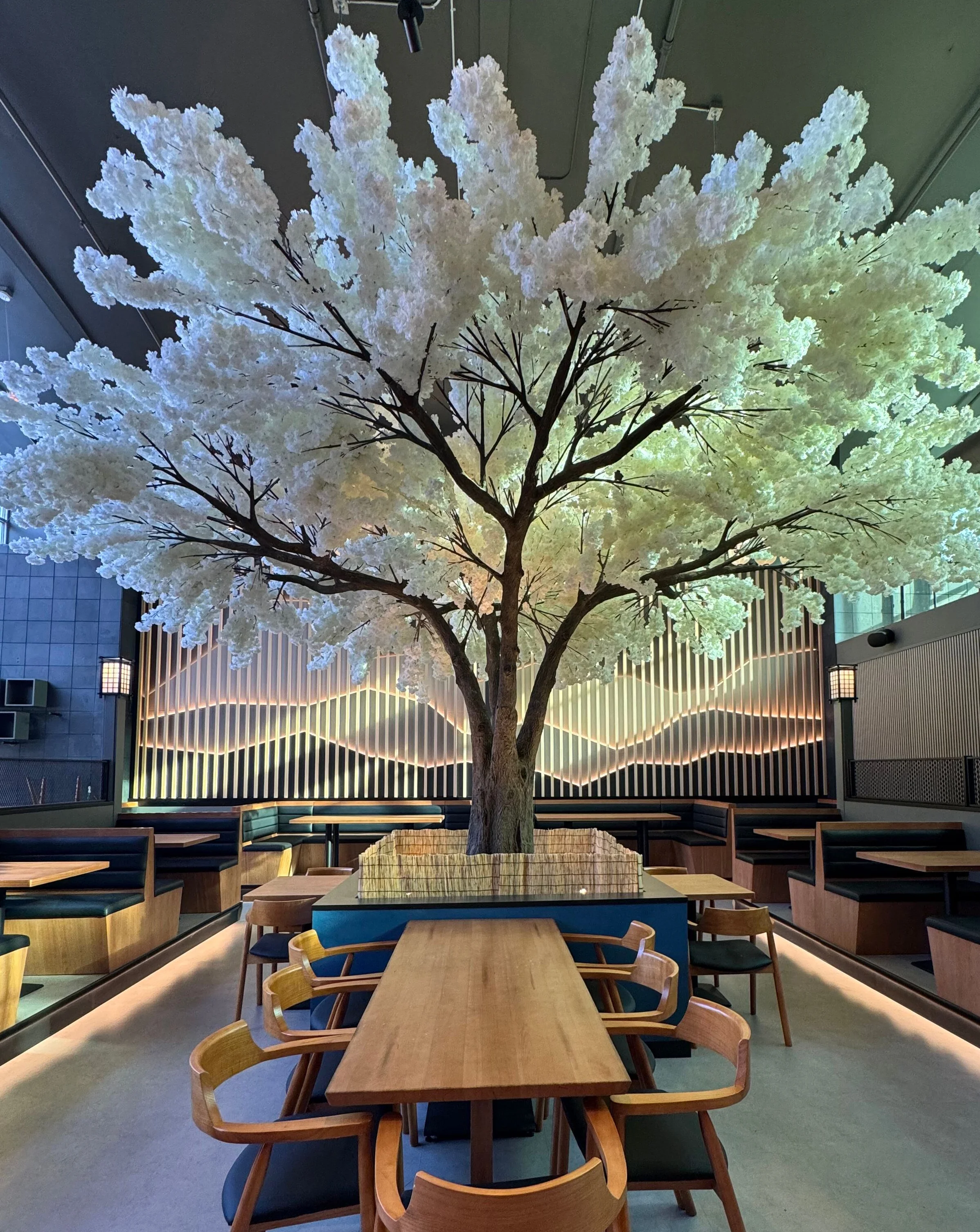 Stylish restaurant interior with a large decorative tree