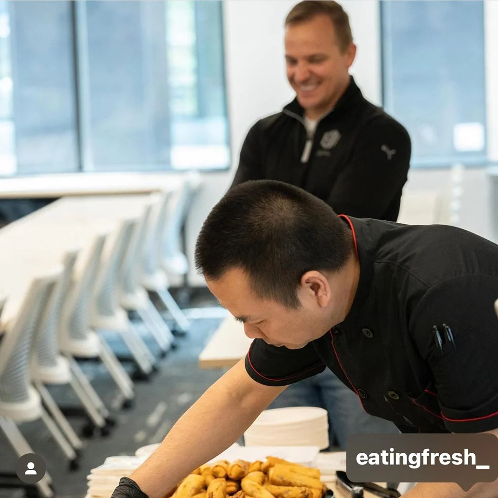 Chef preparing spring rolls in a modern kitchen setting