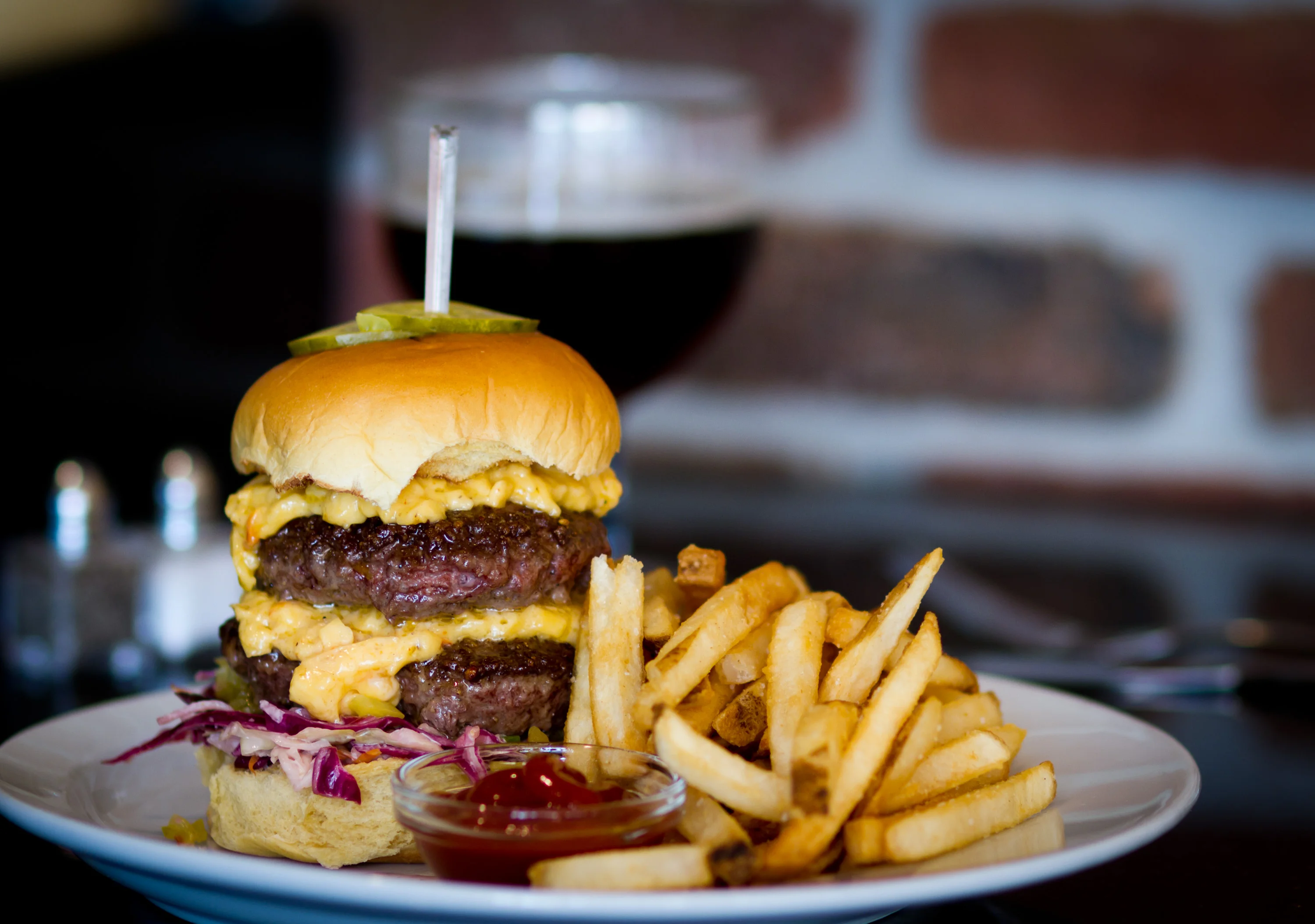 Juicy double cheeseburger with fries in a casual dining setting